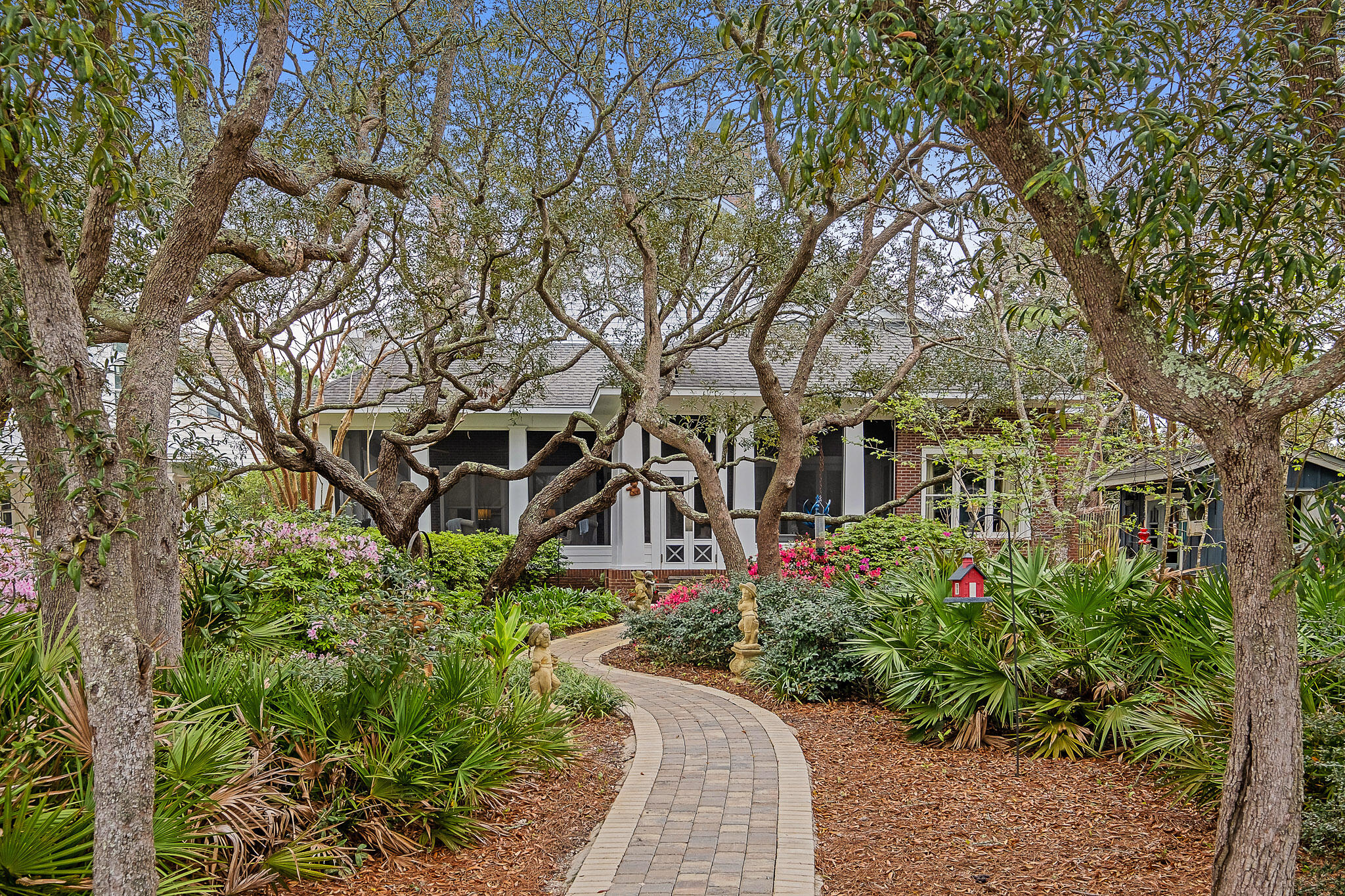 The true epitome of bayfront living awaits you in this stunning New Orleans inspired home off of Mack Bayou. Surrounded by the serenity of the live oak canopy, the backyard sets the stage for westward facing sunsets overlooking the peaceful waters. Ideal for boaters and fisherman alike, Mack Bayou has some of the deepest water available in South Walton, allowing for the mooring of larger boats than most of the surrounding bayous.  The dock includes an approx. 20' covered slip with lift, fish cleaning station, multiple jet ski lifts, and pilings in place on the side slip for a larger vessel. While entering the property, you are greeted with a 3 car garage that includes a large finished carriage/apartment above with spacious open floorplan kitchen/living room, plus a large Bedroom and