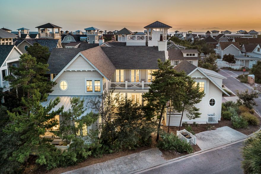 This incredible Watersound Beach home offers 3,499 sf of beautifully designed living space including 4 bedrooms, 4.5 baths in the main house, 2 living rooms. The home's carriage house sits atop it's 1.5 car garage and includes another bedroom, full bath and wet bar! Upon entering the home you will notice the 12 ft ceilings, and eye-catching hand-scraped oak flooring. The kitchen is finished with Thermador appliances and marble countertops, and the home's fireplace, coffered ceilings and shiplap accents add texture and warmth to the main living area. Also found on the main level are a powder room, laundry facilities, and the first of 2 master suites. This master's ensuite bath has a stately oval window separating the 2 vanities, and marble covers every surface. The second level of the home