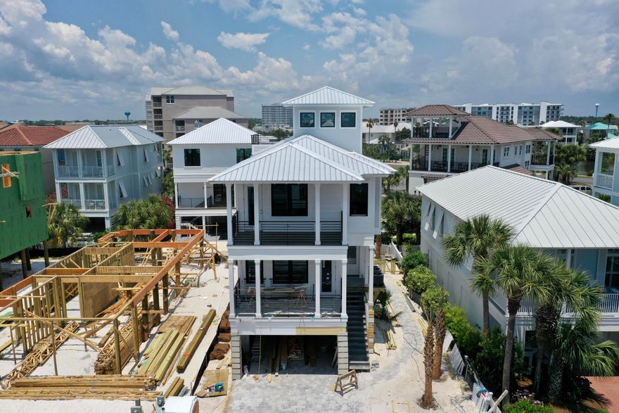 Rare opportunity to own a beautiful, brand-new construction in Destin Pointe! This home has it all, boasting upgrades galore on all four levels with tons of natural light and shiplap wall accents throughout. The first floor offers a partially covered, heated saltwater pool with a brick paved deck. The main level boasts open concept living with kitchen, dining and living room flowing into the spacious front deck. The chef's kitchen is equipped with a ZLINE gas range, Kitchen Aid appliances, Brizo luxe fixtures and faucets, quartz countertops, floating shelves, and soft close cabinets. Just beyond, you'll find a lovely private bedroom, including an ensuite bath and large private deck. On the third floor you will enjoy this home's 3 additional bedrooms along with a 5-bed bunk room. Two of