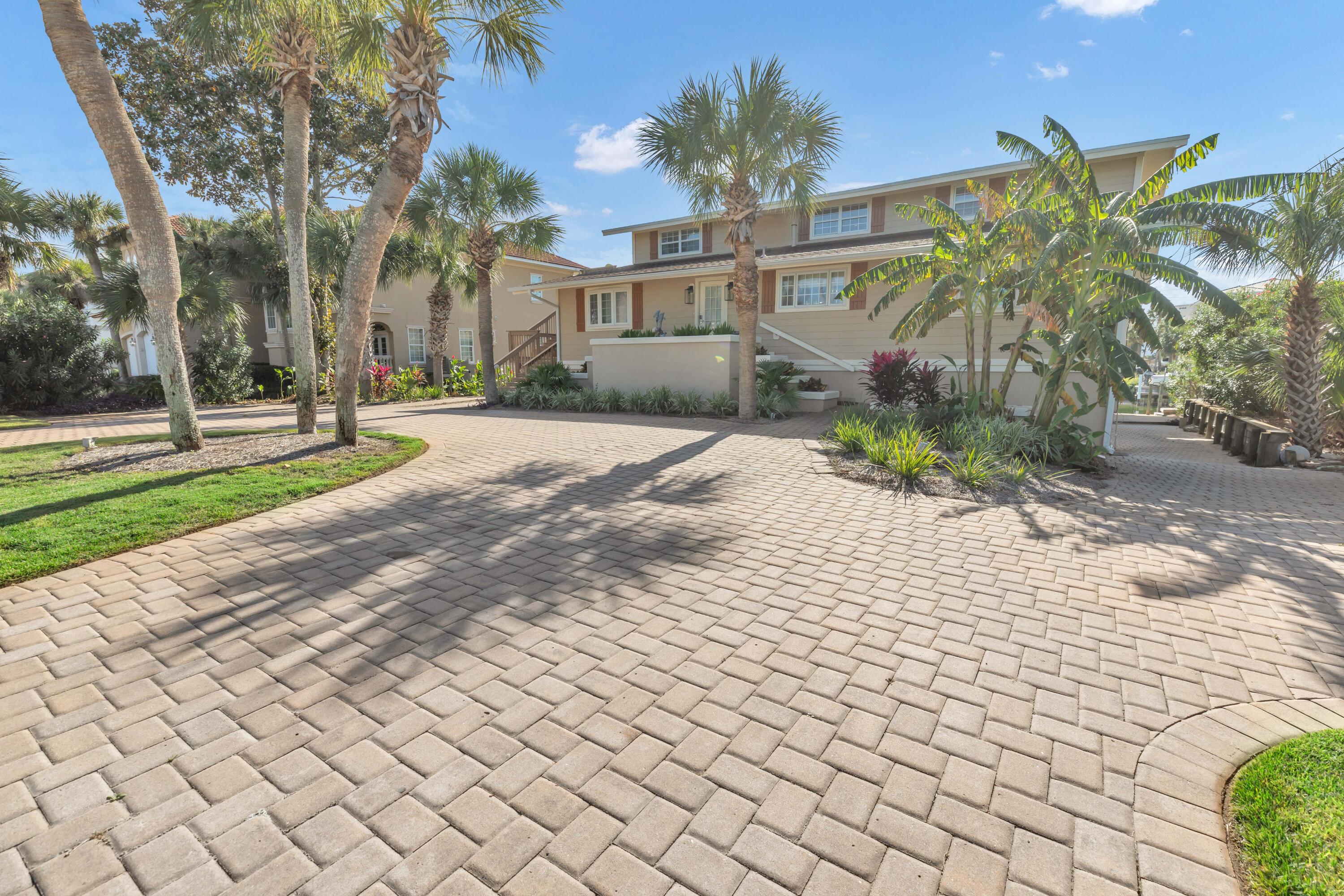 Nestled in the highly desirable area of Holiday Isle.  This exceptional waterfront beach home offers the perfect blend of coastal living and modern convenience. Situated just one block from the beach with Gulf views and directly on a deep-water canal, this home is truly a rare find.  What sets this property apart is its unique features, including a fully covered and enclosed outdoor entertainment area with observation deck and two covered boat slips with lifts, and an impressive 90 feet of deep-water frontage. The home boasts two separate living areas (2nd Level - Main Level and 3rd Level Lockout) each with their own private entrances totaling six spacious bedrooms, six full bathrooms and two fully equipped kitchens, providing ample room for family & guests. The main floor is comprised of 4 spacious bedrooms and 4 baths, large living area, gourmet kitchen with breakfast bar and an office.  The 3rd Level Lockout is comprised of 2 bedrooms with 2 full baths, living area, kitchen with breakfast bar. These two living areas can be utilized together or kept separate. Additionally, the lower level offers 2,500 square feet of unfinished space, perfect for storage, work area or customized to suit your needs. With its prime location, you're only eight houses away from the private beach access of Holiday Isle and a 15-minute boat ride to Crab Island or the Gulf of Mexico. Whether you're seeking a luxurious permanent residence or a lucrative investment property, this home delivers on all fronts. Embrace the best of waterfront living in this stunning Holiday Isle retreat. Short term rentals are allowed.  Rental projections are $150,000 - $175,000.