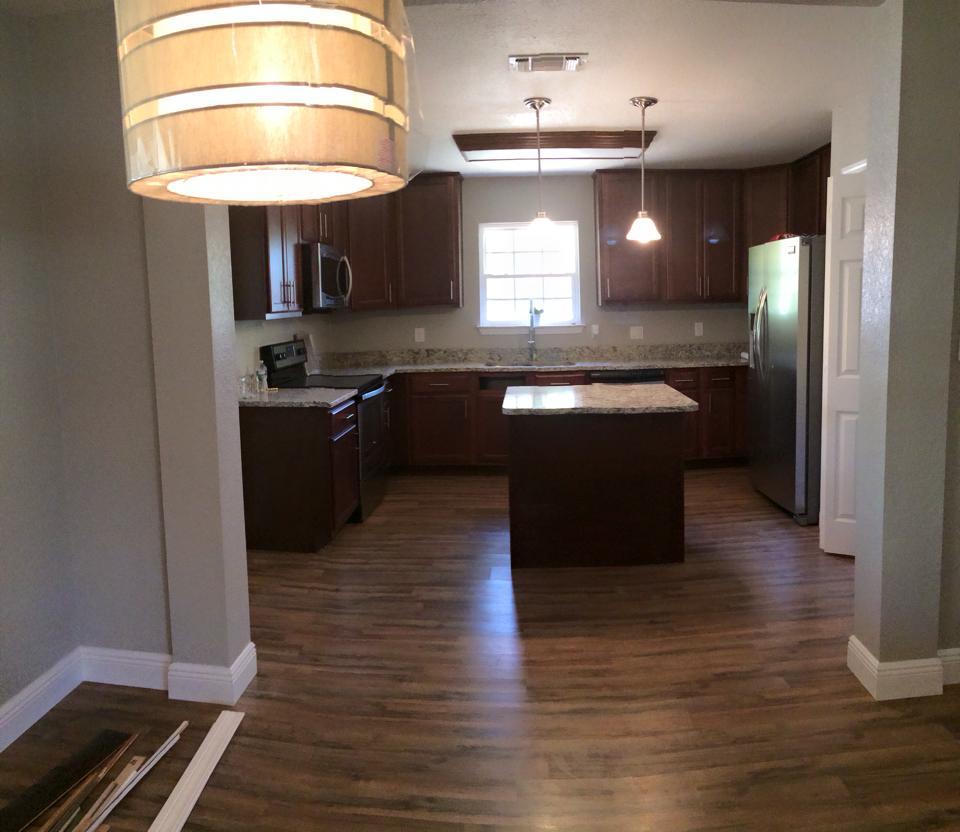 Great 4 bedroom home that has been completely remodeled. New shingles, flooring, cabinets, windows, appliances light fixtures and wiring, garage doors. Master has walk in closet, 4th bedroom has private entrance to hall bath. Large lot with mature trees (pecan tree!). Covered back porch. Kitchen is open with island and stainless appliances. Laminate wood flooring, tile thru out except carpet in bedrooms. No old popcorn ceiling-new textured ceiling with beautiful tongue and groove ceiling in living room. Back yard has privacy fence. This is a must see!!!