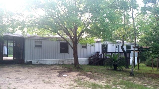 This is a great cash or owner finance deal. With an entire acre of privacy, this home features the peace and quiet from town. The kitchen has a built in cassette player and lots of cabinet space. This home has a large living area with fire place. The bedrooms are spacious with plenty of storage. As you enter the master you are greeted with a large garden tub and separate sinks. This home needs some love and TLC but will make a great private home you can love.