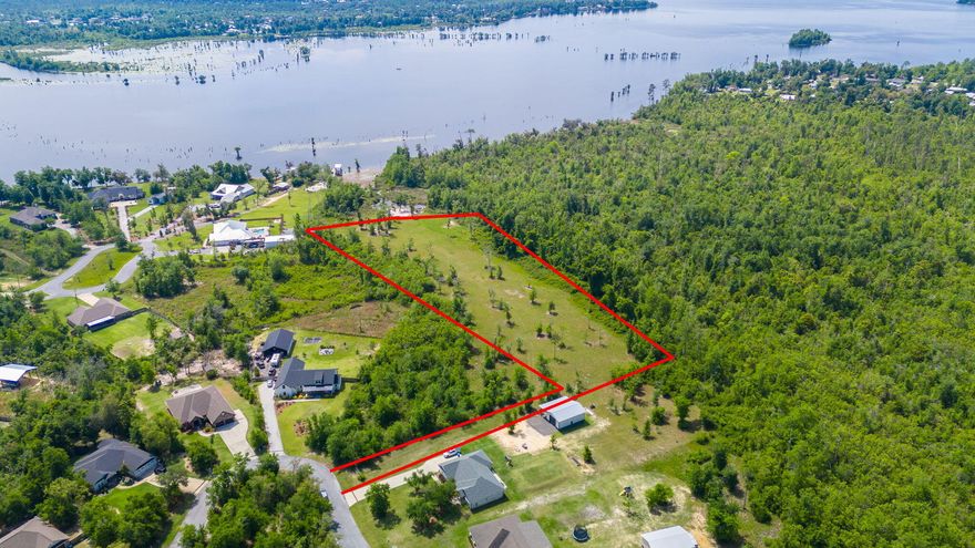 Discover this UNIQUE WATERFRONT opportunity to build your dream home on a rare 5.52-ACRE homesite, the largest available in the stunning Cedar Creek community on Deer Point Lake. This expansive property with approximately 381' of water frontage offers an idyllic blend of beauty and seclusion, nestled within a serene wooded paradise. With highly desirable water frontage and direct lake access, the possibilities are endless for creating your perfect retreat or compound. Whether you envision a pole barn, entertainment center, pool with pool house, or additional detached garage, this homesite provides ample space for all your needs, including storage for your RV, camper, boat, or other recreational vehicles. 
This site has been cleared yet many trees still remain creating a private oasis but still allowing you to begin building immediately without the cost of clearing land! 

Cedar Creek is a master-planned community that harmoniously integrates with the natural landscape, preserving its tranquil surroundings for residents to enjoy for years to come. Known for its excellent fishing opportunities, Deer Point Lake is a haven for bream, shellcracker, and bass enthusiasts. Its proximity to Econfina Creek also offers easy access to the vibrant offerings of Panama City and the surrounding areas, all while enjoying the benefits of waterfront living. 

Residents of Cedar Creek benefit from exceptional community amenities featuring a large community pool, playground, golf cart-friendly streets, and abundant greenspace, creating a country feel while remaining in a highly desirable location. Wildlife is abundant, enhancing the natural charm of the area. The community clubhouse is available at no cost to residents, making it an ideal venue for hosting events such as birthday parties and showers and family gatherings. 

This is your chance to own a unique 5.52-acre waterfront homesite to build your dream home in one of the most sought-after communities. Imagine waking up each morning to the stunning views of Deer Point Lake, fishing from your own shoreline, or exploring the waters by kayak or skiff. The expansive footprint of this oversized homesite is ready for you to build your dream home and embrace the unparalleled lifestyle that waterfront living offers. Don't miss out on this rare opportunity to create your personal haven in Cedar Creek. 

Adjacent .9-acre interior homesite is also available. Please inquire for more information.