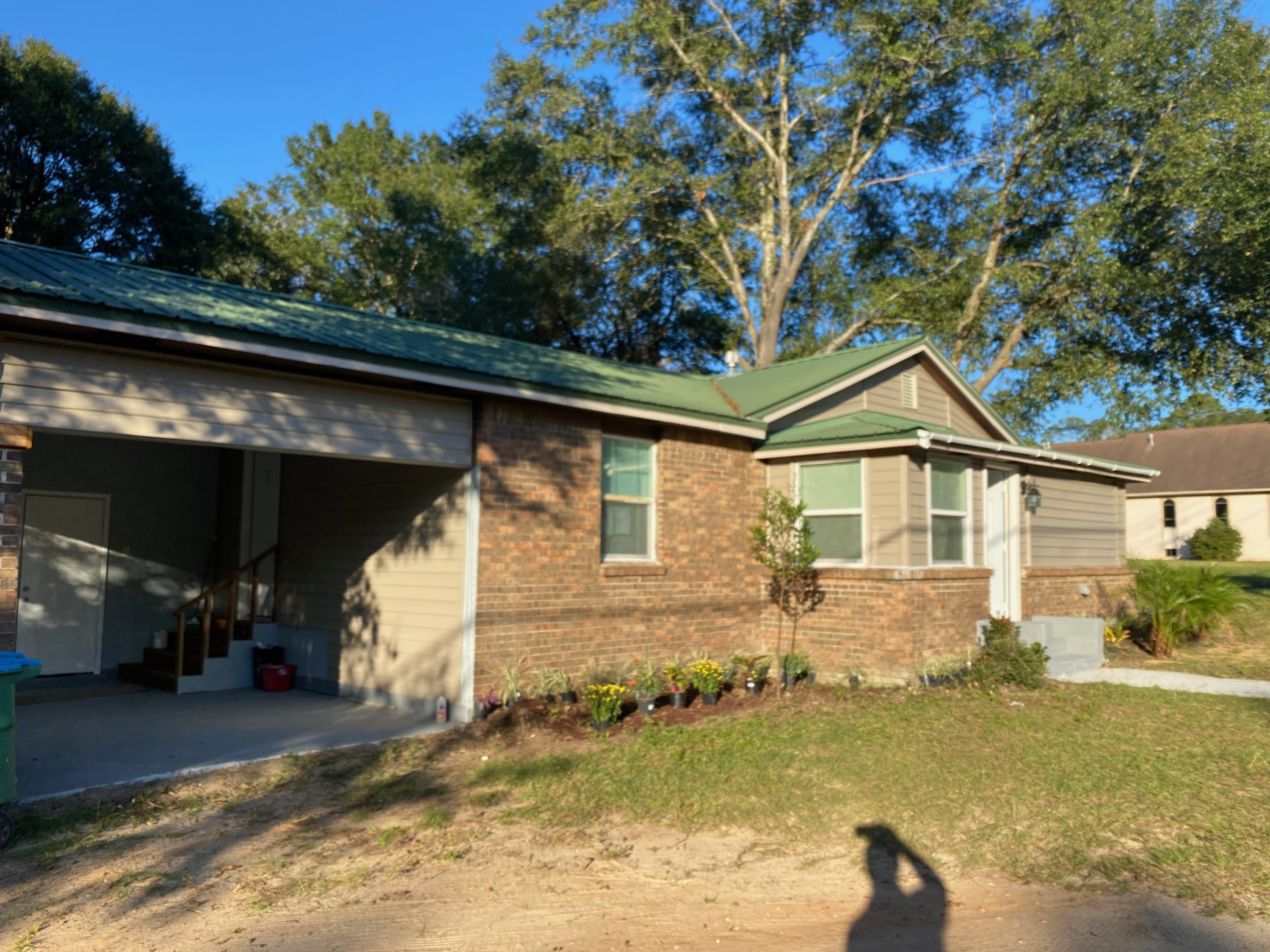 Location,location is the best for this charming brick with metal roof 1140 SF living only 5 min walking distance to Supermarket,gas station, many services and stores, restaurants, H90 road etc. Save your time for all your needs.Interior renovated with approved code inspections, new A/C and new electrical rewired, kitchen with granite top, all new appliances,2 large baths,w/tile and 42in cabinets w granite top.Master bed w walk in closet.Many possibilities,Carport easy and cheap to close and transform in a garage.Very large corner lot with space for playground or new construction.You make your choice.