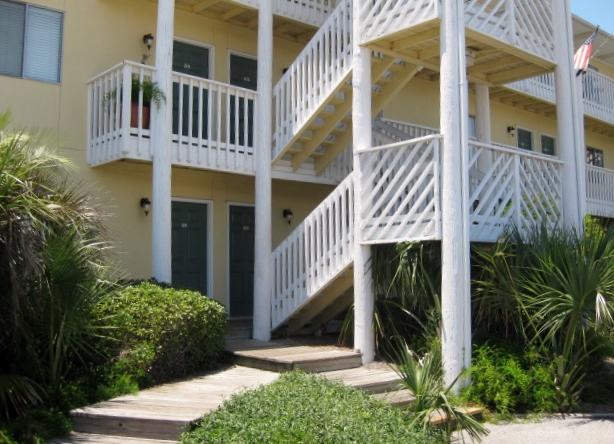 Great opportunity to live on Holiday Isle for under 100K! This one bedroom condo is just waiting for you to put some lipstick and blush on it. No hauling groceries up the steps - you're on the ground floor!! Just a short walk from the beach and you're home! Buyer to verify all measurements.