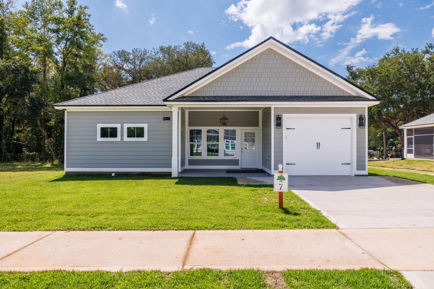 Offering $10,000 Flex Money!!!Welcome to the custom built Magnolia Cottage, a beautifully designed, custom-built 2 Bedroom/2 Bathroom home with a garage, located in the tranquil and growing community of Live Oak Cottages in Freeport, Florida. This stunning 1,279 sqft residence offers a perfect blend of modern luxury, energy efficiency, and stylish finishes, making it an ideal place to call home.Key Features:Durable Construction & Premium MaterialsBuilt on a solid 3000 PSI concrete slab with a 7/12 roof pitch, this home ensures both long-lasting durability and superior weather resistance. The exterior is finished with low-maintenance Cementous Hardie Board siding, complemented by Polygene fiberglass-insulated windows and doors to enhance energy Modern & Efficient Interior- Inside, the home offers 10-foot ceilings that create a bright and open atmosphere. The open-concept floor plan seamlessly connects the kitchen, living, and dining areas, making it perfect for both entertaining and everyday living. Luxury Vinyl Plank (LVP) flooring runs throughout, while custom cabinetry, a gourmet kitchen with quartz countertops, and stainless-steel appliances bring both style and functionality.

Spacious Bedrooms & Luxurious Bathrooms- The primary suite features a luxurious en-suite bathroom with a double vanity, quartz countertops, and a roll-in tiled shower for ultimate relaxation. The second bathroom offers a deep soak tub with a tiled shower combination, making it perfect for unwinding after a long day.

Outdoor Living at Its Best- Enjoy the 12x10 tiled and screened back porch, ideal for year-round relaxation. The fenced backyard offers privacy and security, while two exterior water faucets provide added convenience for outdoor chores or gardening.

Energy-Efficient SystemsThis home is equipped with a 2-ton, 15 SEER HVAC system with a programmable thermostat for optimal comfort year-round, as well as a 40-gallon hot water heater to meet all your utility needs.
Prime Location- Live Oak Cottages is ideally situated in Freeport, FL, offering a quiet, serene setting while being just minutes from vibrant local shopping, dining, and schools. You're also less than 25 minutes from the beautiful beaches of 30A and the stunning Emerald Coast.

Don't miss this opportunity to own a thoughtfully designed, energy-efficient home in one of Freeport's most desirable communities. Schedule your private showing today!
