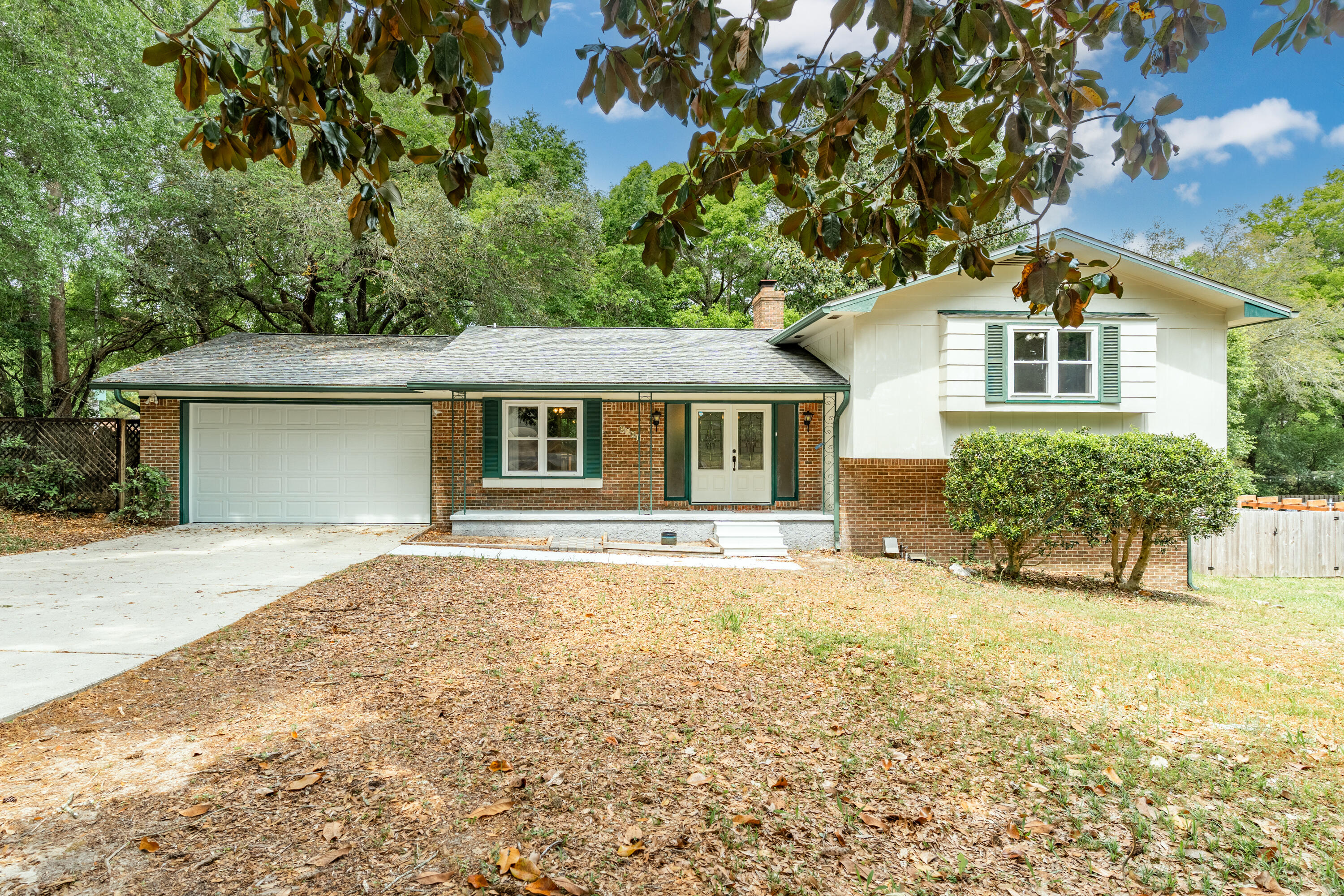 Spacious 4 bedroom split level home with a deck and huge backyard with a private wooded backdrop. The main level offers a welcoming layout with an open living and dining area highlighted by the stone fireplace. The kitchen includes a cozy breakfast nook. Upstairs, you will find two generously sized guest bedrooms with ample closet space, a full guest bathroom, and a spacious primary suite featuring a vanity area, walk in closet and a private water closet. The lower level is perfect as a guest suite or bonus living space, complete with a spacious living area, unique fireplace with brick accent wall, a large guest bedroom. a full bathroom with walk in shower and a utility room for washer and dryer. Step outside to your back deck, and enjoy the backyard that backs up to a peaceful wooded are