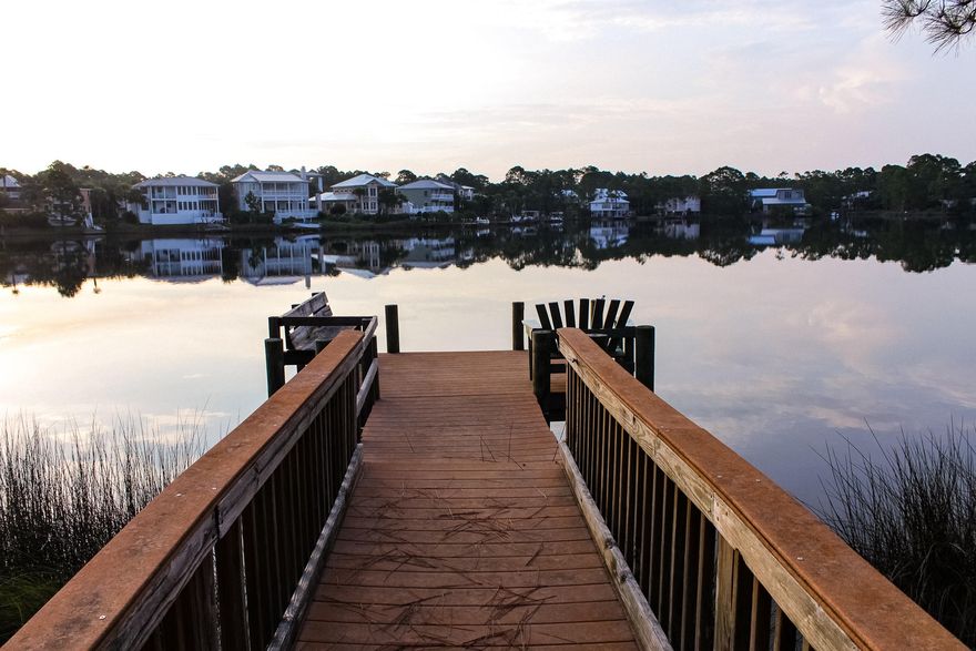 Rare Coastal Dune Lake Beach House with 75 feet of Waterfront on Eastern Lake! South Side of 30A, Short Walk on Lake Drive, or Paddle across the Lake to the White Sandy Beach and Enjoy the Gulf! 67 S. Lake Drive is a 1,946 sq. ft., two story, 4-bedroom, two bath home with large covered porches on each floor, offering breath taking views of Eastern Lake. Walk down the dock from the first-floor covered screen porch and enjoy the breeze off the lake and gulf. Each floor has an open living room and eat in kitchen area, a custom-built brick wood burning fireplace and a side covered porch, designed to enjoy the views and atmosphere of old Florida living. Both bathrooms connect each of the two bedrooms on each floor with a Jack and Jill entrance, each with a washer and dryer area. The property was built and designed as a family beach vacation home, owned by the same family for three generations. Each floor has separate outside entrances allowing family and friends to come and go as they please. The property is in a platted subdivision zoned Residential Preserve, which allows only one home per platted lot. On this ½ acre lot you can enjoy privacy in a low-density neighborhood. This home has so many possibilities, as a primary residence or to continue as a family retreat.