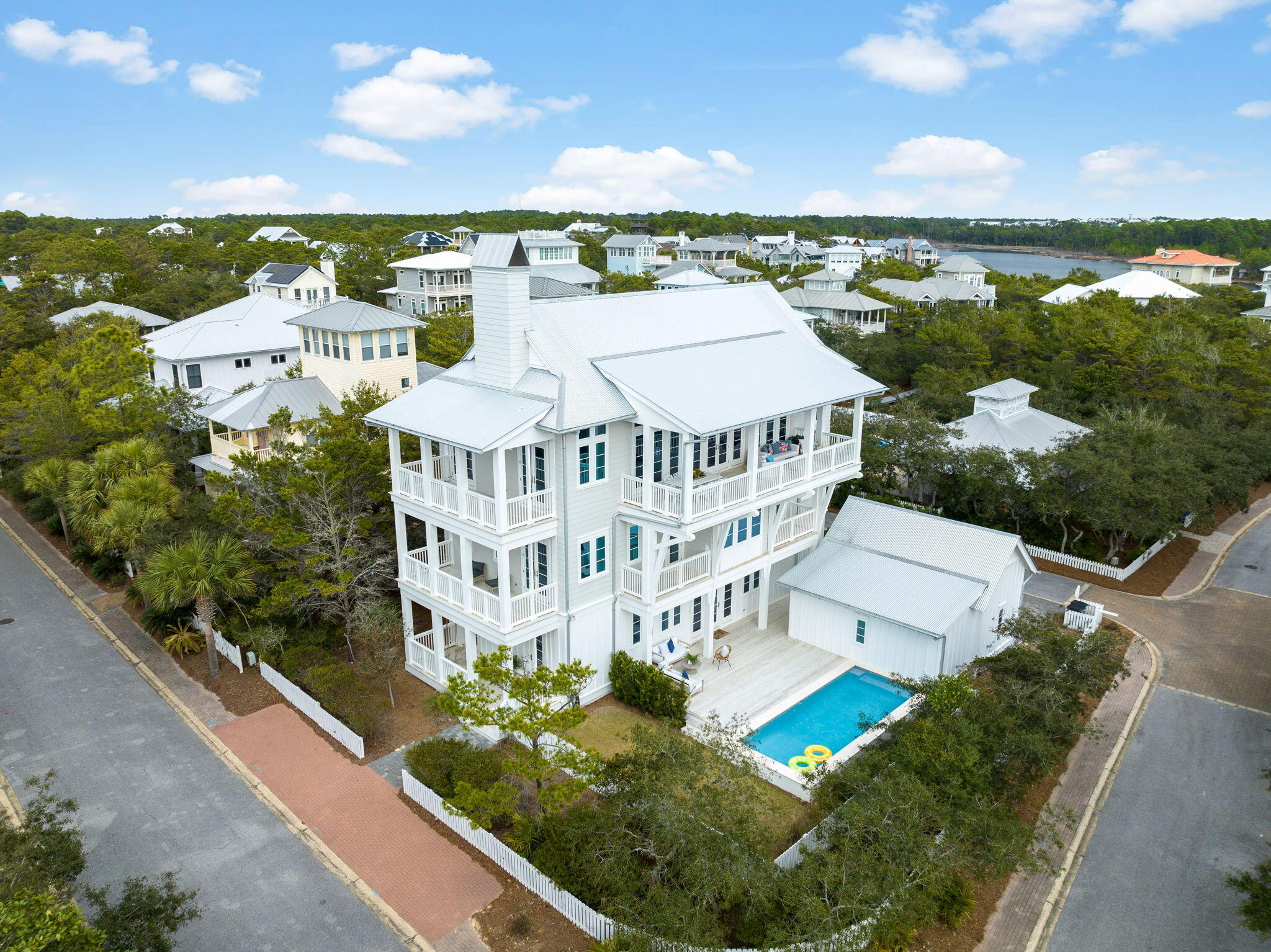 Welcome to the exclusive private gated beachfront community of Old Florida Beach, where you'll find the lifestyle you've always dreamed of. This Geoff Chick & Associates custom-designed home is a coastal retreat offering endless opportunities to gather, entertain and simply relax.This 4,100-square-foot home features six bedrooms, each with an ensuite bath, double primary suites each with a freestanding tub and oversized shower, bunk beds for the kids, and a convenient three-stop elevator. The main living floor boasts vaulted beam ceilings and a south-facing covered balcony, perfect for lounging and dining while overlooking the Gulf. The gourmet kitchen, with its extra-large island, walk-in pantry, and breakfast nook, ensures everyone can be part of the fun. Additional features include a two-car garage, 12' Ceilings, two laundry areas, a commanding corner lot, and a welcoming front porch with swings. Designed for fun and relaxation, the large pool with EPI decking, lounge area, and grassy side yard provide everything you need for outdoor enjoyment.
Take advantage of the private beach access just across the street and community dock, where you can enjoy fishing, paddle boarding, or kayaking on one of the rare Coastal Dune Lakes of 30A. Explore the area's trails or simply unwind around your own private pool. Whether you are personally enjoying this magnificent home or looking for a real estate investment, this property checks all the boxes. This is a rare opportunity to be a part of such a small community with its own private beach, just moments from Gulf Place, Seaside and all the dining, shopping and entertainment that 30A has to offer. 