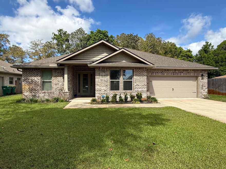 This newer, all-brick home in Fort Walton Beach offers 4 bedrooms and 3 bathrooms, combining modern design with high-end finishes throughout. Conveniently located just minutes from military bases, beautiful beaches, and local shopping, this home provides both comfort and accessibility.

Designed with an open-concept layout, the home features soaring 9- and 10-foot ceilings and luxury vinyl plank flooring that runs seamlessly throughout the entire space. The spacious bedrooms and three full bathrooms are thoughtfully designed, complemented by a custom lighting package with energy-efficient LED fixtures that enhance the home's bright and inviting atmosphere.

The kitchen is a true centerpiece, showcasing a stunning 12-foot center island, quartz countertops, custom glass backsplash, and all-wood paneled cabinetry with soft-close drawers and doors. Stainless appliances, including a gas range and French door refrigerator, complete this chef-inspired space. A walk-in pantry provides additional storage, making the kitchen both functional and stylish.

Attention to detail continues with a custom trim package featuring wide door casings, large cove crown molding, and window casings in nearly every room. The dining area is highlighted by impressive double 8-foot barn doors, adding both character and flexibility to the space.

The primary suite offers a luxurious retreat with a large walk-in closet and a beautifully designed bathroom that includes a floor-to-ceiling tiled walk-in shower with accent details, a built-in bench, and a frameless glass door. A separate 5-foot freestanding soaking tub with a tiled wall surround adds a spa-like touch.

Additional upgrades include a gas range and BBQ stub on the back porch, epoxy flooring on both the porches and garage floor, full-home guttering, and an extra-large fully landscaped fenced yard, perfect for outdoor enjoyment.

Pets may be considered on a case-by-case basis with prior owner approval and a non-refundable pet fee. This is a non-smoking property, and vaping is also prohibited, ensuring a clean and comfortable living environment.