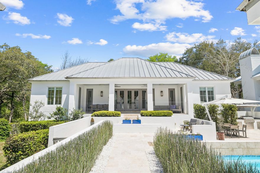 Located in the heart of Old Seagrove, this private beachside compound offers upscale coastal living just steps from the sand and from Seaside and Watercolor. This thoughtfully designed and gated property features a main residence, carriage house, and a beautiful courtyard with a resort-style pool. The interior living space is anchored by a finely appointed chef's kitchen complete with custom cabinetry, waterfall countertop, and stainless steel Thermador appliances, including a 48-inch gas range. Wide-plank oak wood flooring, custom millwork, and designer lighting extend throughout the home, while the open living area centers on a gas fireplace and is filled with natural light, creating a warm and inviting atmosphere. The main level includes three spacious king suites, each with a spa- -inspired bathroom featuring marble flooring and a glass walk-in shower. The lower level offers a second living and game area, a bunk room with queen-over-queen beds, and two additional bedrooms for added flexibility. Overlooking the pool, the ground level carriage house includes a rare full kitchen, bright living space, dining area, and king suite, ideal for guests seeking a more secluded retreat. With six bedrooms, six bathrooms, no HOA, and an unbeatable private location near dining, shopping, and beach access, this property is an exceptional opportunity to own a luxury home along 30A.