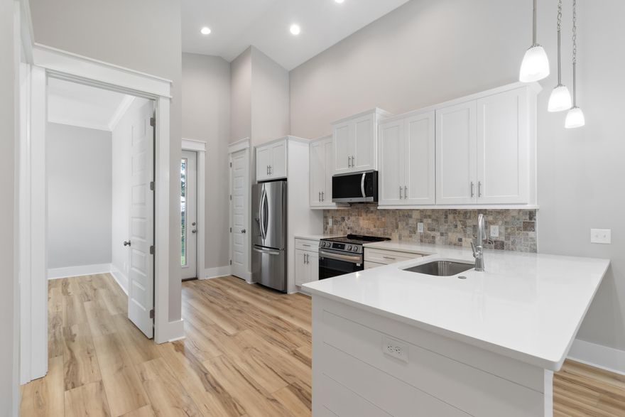 This beautifully finished 3 bed, 2.5 bath home offers 1,398 sqft of stylish comfort just 10 minutes from the beach! Featuring LVP flooring, tile showers, shiplap accents, vaulted and trey ceilings, crown molding, and a fenced backyard — all with no HOA. Prime location near the bay and the future Chat Holley park & amphitheatre makes it perfect as a full-time home or a high-performing rental! Construction complete as of 10/1/2025! Seller will install a wood privacy fence with an acceptable offer. Watch the Youtube video here : https://www.youtube.com/watch?v=eKqJhctS40E