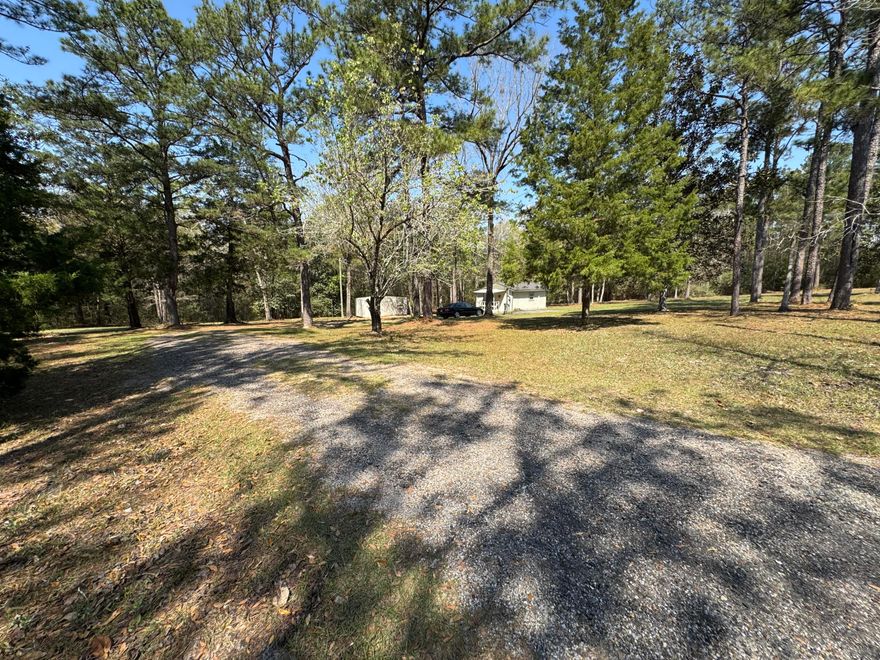 Nestled on a private and beautifully wooded 1.6-acre homesite, this unique 
property offers the perfect blend of peaceful country living, modern upgrades, and future expansion potential. Surrounded by mature trees that have been professionally thinned and trimmed, the lot provides privacy while still offering ample space to build a primary residence, guest home, or additional structures. This is a charming, small home. 
The interior showcases a warm and inviting aesthetic, all remodeled recently creating a cozy yet refined living space. Many recent upgrades include new high efficiency hvac split system, new hot water heater  A complete list of recent major upgrades are provided in the attached documents. Outdoor features further enhance the property's versatility, including a dedicated RV/camper parking space with water hookup and 50-amp power, making it ideal for guests or additional living flexibility.
The property also includes a functional 12x20 storage shed and a private well house, both recently improved.

Bonus: The sale includes 2 refrigerators, microwave,  flat screen tv,  and washer/dryer, and yard tools making this a turnkey opportunity for a primary residence, weekend getaway, or investment property.
This is a rare opportunity to own a private acreage property with modern upgrades, RV accommodations, and room to expand--all in a serene, natural setting.