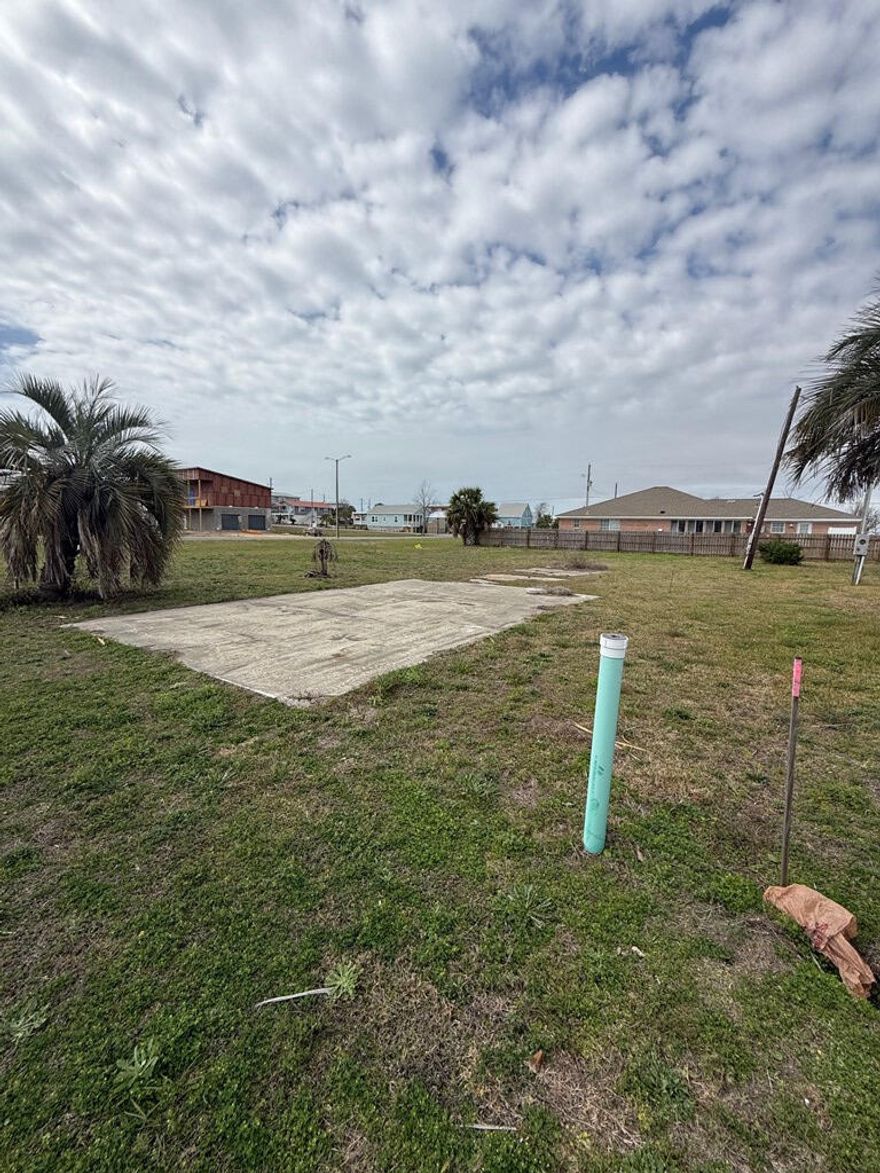 Corner lot located approximately 800 feet from the beautiful, sugar white sands beach with dedicated public access. This X flood zone lot was a former homesite and already has water and sewer taps paid. There are also some established palm trees, an existing driveway, and electric stub out. Many options for building as the X flood zone designation allows one to build on grade if desired. Quiet neighborhood with a nice boulevard (Florida Ave) for added privacy. Priced to sell and will not last long.