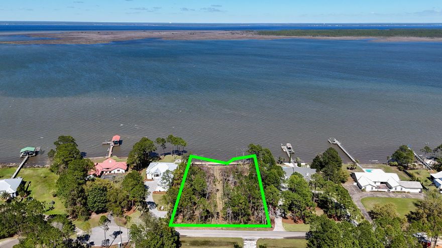 This exceptional over-one-acre estate size bayfront /bayou lot boasts approximately 170 feet of pristine waterfront on a quiet Woodland Bayou cul-de-sac, creating an extraordinary opportunity to build a private coastal retreat in beautiful Walton County. A significant advantage of this property is that approved permits from the Florida Dept. of Environmental Protection (FDEP) and the U.S. Army Corps of Engineers are already in place -a process that can take up to two years or more to complete. Additionally, a permittable set of architectural house plans is available that feature four-bedroom,3 car garage, and pool potentially saving substantial time in the design and permitting process and allowing the next owner to move more quickly toward construction. Imagine unwinding in your custom- built waterfront home featuring sweeping bay views, private waterfront access, and breathtaking sunset vistas each evening. Spend your days fishing for trout and redfish from your future dock, launching your bay boat for trips to area restaurants, a trip to crab island or just to cruise and explore all the abundant waterways. Or just put in a paddleboard or kayak and catch some dolphins playing. Another beauty of this property is the short distance to 30A, Miramar Beach, or spending a day on the sugar white beaches of the Emerald Coast. Properties offering over an acre of bay front land,170 feet of waterfront, completed environmental approvals, and available architectural plans are exceptionally rare making this incredible opportunity to move forward with building far sooner than typical waterfront properties allow. This is one not you do not want to miss out on seeing.