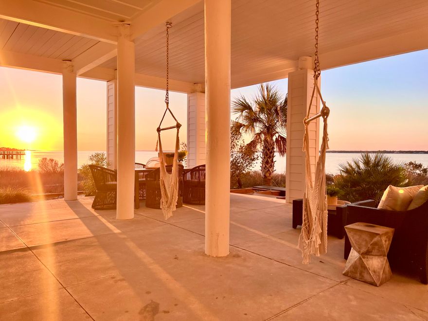 Experience serenity inside and out of this stunner! Discover luxurious island living in this beautiful waterfront home on Navarre Beach, perfectly situated on a white sandy beach with breathtaking water views of Santa Rosa Sound from every window. Nestled in the quaint, gated 'By the Sea' community, this professionally interior-designed, fully furnished luxury beach house offers the ideal retreat or smart rental investment. This customized home features two oversized ensuite bedrooms, each with a private balcony, along with two large guest rooms and two versatile bonus rooms—perfect for a variety of needs including additional sleeping space. The ground level includes an approximate 600 sf of gorgeously finished, air conditioned space with a full bath, creating the possibility of use as a 5th ensuite bedroom or added living area.

Step outside to your back patio, surrounded by exotic palm trees and tropical plants, where you can enjoy a crackling fire pit and entertaining guests. The home provides direct access to the Sound side beach and water activities, including sailing, jet skiing, paddleboarding, fishing - all right outside your back door.

This home was beautifullly remodeled in 2023-2024. Upgrades include: new high efficiency Bryan AC systems with REME Halo purifier and auto cleaning; 2 car garages added/ enclosed with 210 car charger; New decking on front porch to add dry deck of garage, and new/ improved railings; Ground level air conditioned room/ bathroom; Full paint inside and out; All floors and tile surrounds replaced; Backsplash installed in kitchen and primary bath; Total kitchen remodel with enlarged island, added upper cabinets with new drawers and fronts, new countertops; All lighting and fixtures in home replaced; All new furnishings and interior design; Additional bathroom on second living level; Landscaping updates including turf; Epoxy flooring on the ground level has just been installed Jan 2026 to create an even more finished space.

Enjoy the community's amenities, including a sparkling pool, deeded beach access to the Santa Rosa Sound, and a friendly atmosphere. Year-round sunsets create a truly magical setting, making this residence perfect for large family reunions or a peaceful retreat. With easy access to the Gulf of Mexico (just a five-minute walk), this charming, quaint community offers an unparalleled coastal lifestyle.