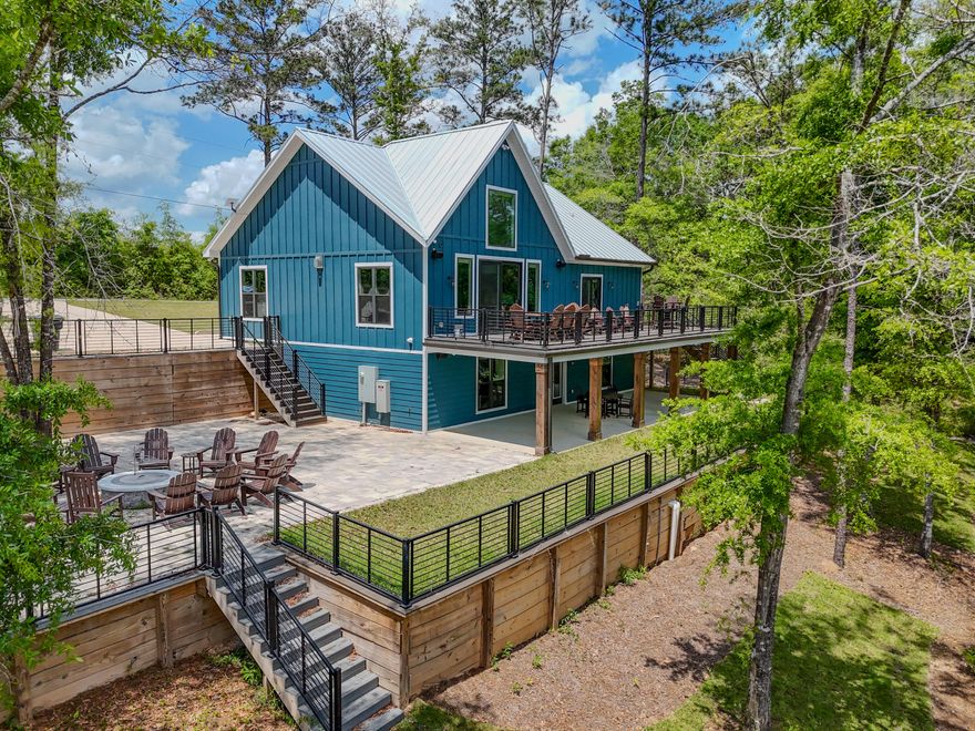182 Blue Pond Rd is one that just feels right when you're there. Set on Blue Pond in a quiet corner of Ponce de Leon, this 2023-built waterfront home offers privacy, peaceful views, and an easy drive to Freeport, South Walton, and the beaches. The main level features open kitchen, living, and dining spaces oriented toward the water, plus a large deck for taking it all in. What truly sets it apart is the fully finished lower level with a second kitchen, wet bar, living area, and additional guest space, creating an ideal setup for hosting or multi-generational living. Sold furnished and professionally decorated, this is a rare opportunity for turnkey waterfront living, whether full-time or as a second home.