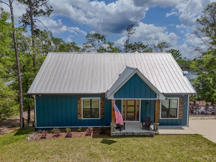 182 Blue Pond Rd is one that just feels right when you're there. Set on Blue Pond in a quiet corner of Ponce de Leon, this 2023-built waterfront home offers privacy, peaceful views, and an easy drive to Freeport, South Walton, and the beaches. The main level features open kitchen, living, and dining spaces oriented toward the water, plus a large deck for taking it all in. What truly sets it apart is the fully finished lower level with a second kitchen, wet bar, living area, and additional guest space, creating an ideal setup for hosting or multi-generational living. Sold furnished and professionally decorated, this is a rare opportunity for turnkey waterfront living, whether full-time or as a second home.