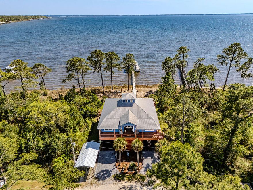 Waterfront, turnkey and made for easy Florida living.  This 3-bedroom bay front home with guest quarters blends coastal charm with a great entertaining space and big water views from every room. 

Custom built bay front home on pilings with private dock, covered boathouse, and a boardwalk to the Choctawhatchee Bay.

Open concept main level with vaulted tongue and groove ceilings, rich wood floors and walls of windows overlooking the bay.

The gourmet kitchen features granite countertops, large center island, breakfast bar, and stainless-steel appliances, all open to the dining and living areas for effortless entertaining. 

Spacious decks on the front and back that run the length of the home, offers plenty of room for dining, lounging and soaking in panoramic views.  Don't miss this gem!!
