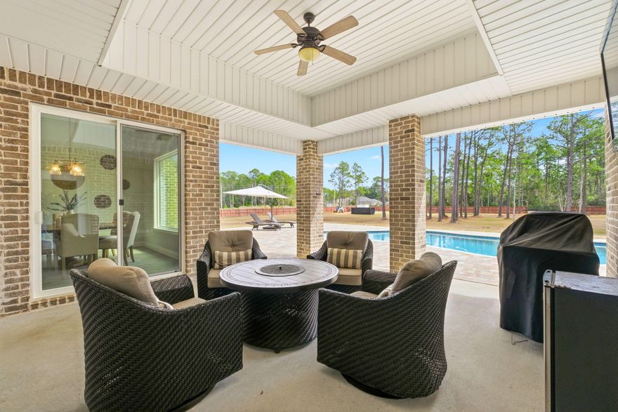 Welcome to a truly rare, one-of-a-kind 3+ ACRE DREAM HOME in Navarre--where privacy, space, and convenience come together. Acreage of this size is typically found far outside town, yet here you are just 15 minutes from the beach, enjoying the best of both worlds. An exceptional opportunity like this is rarely available, especially within a community offering a low HOA of just $595 per year.

This custom, one-owner home offers over 3,300 square feet of heated and cooled living space, complete with an inground pool and paid-in-full solar panels, providing long-term energy efficiency and savings. A brand-new, oversized HVAC system was installed in July 2025, thoughtfully selected for enhanced comfort and efficiency throughout the home. Natural light pours into the expansive entryway, welcoming you into a thoughtfully designed layout featuring four spacious bedrooms with privacy on each end of the home, plus two additional offices--currently used as a den and a children's playroom--offering endless flexibility for work, play, or multi-generational living.

The property is fully fenced with massive front and rear metal gates, making it ideal for storing an RV, boat, or other recreational toys. Vaulted ceilings accent the living room, primary suite, office, and formal dining area, adding volume and elegance throughout. The home was custom built in 2018 and has been meticulously maintained.

Residents enjoy access to a resort-style, multi-million-dollar recreational center featuring multiple pools, tennis courts, pickleball, a fitness center, sauna, steam room, and boat launch access--an incredible amenity at an unbeatable value.

Additional highlights include a large laundry room with a built-in mudroom bench and storage, programmable Wi-Fi thermostat, security system (conveying), stained modern fencing, 13-zone irrigation system, triple-car garage, extended driveway with ample parking, pull-down attic stairs, electric rear gate, and hurricane fabric shields stored for all windows and doors, offering excellent insurance benefits.

The chef's kitchen features rich, dark soft-close cabinetry, two pantries, under-cabinet lighting, gas cooking, and an open flow to the main living area--perfect for entertaining and everyday living.

Most importantly, this is over 3 acres of fully usable land--a rare find in Navarre, where many properties of this size include wetlands or non-usable space.

Located just up the road from the Holley by the Sea boat ramp, this property truly has it all.

Welcome to your 3-acre dream home.