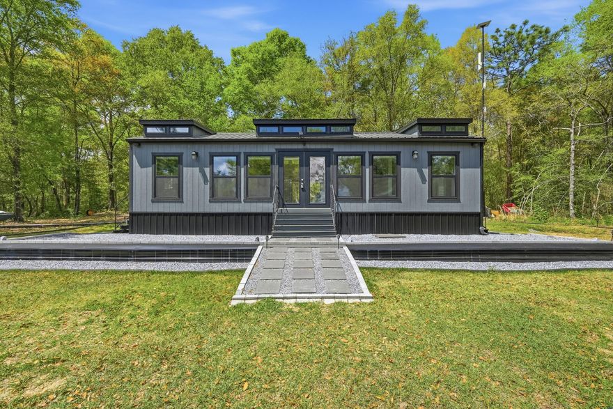 **Tiny Home Living on 4 Acres of Lakefront Paradise**

Welcome to a rare find in the heart of Northwest Florida -- a 2024 charming tiny  home  16x24 nestled on an expansive 4-acre waterfront parcel along the shores of Lake Holley a 400+ acre lake renowned for its trophy largemouth bass fishing. This is more than a home; it's a lifestyle waiting to be embraced.

The spacious 585-square-foot tiny home features 1 bedroom and 1 bathroom, offering a simplified yet comfortable living experience perfect for those seeking to downsize, invest, or create a peaceful retreat. Step outside, and the real magic begins. Approximately 132 feet of pristine waterfront greets you, complete with a private fishing dock where you can cast a line at sunrise or simply soak in the tranquil views. The property comes equipped with essential infrastructure already in place -- a well, a 2003 septic system, and electric service -- saving you significant time and investment. A convenient circle drive provides easy access, while a storage shed with covered parking adds practical functionality for boats, equipment, or vehicles.

Surrounded by natural beauty, you're just minutes from Shoal River Headwaters State Park and Walton High School a short drive into town. The sprawling outdoor space offers endless possibilities for expansion, gardening, or simply enjoying the peaceful Florida countryside.

Four-acre waterfront parcels on local lakes are incredibly hard to come by. Don't let this extraordinary opportunity slip away -- schedule your private showing today!