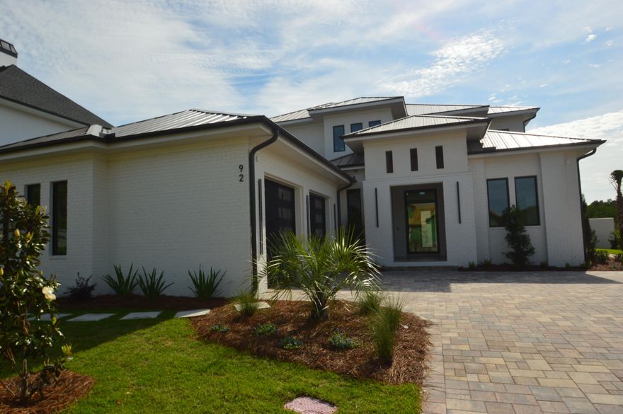 Construction completed - Professional photos coming 5/15. Behind the gates of Watersound Camp Creek, this newly constructed modern masterpiece was designed for buyers who refuse to compromise. Warm white oak finishes and clean architectural lines create a home that feels both sophisticated and effortlessly livable. Expansive Eurowall accordion sliders open completely to a private outdoor retreat featuring a resort-style pool, putting green, outdoor kitchen, and peaceful pond frontage.
Built with exceptional craftsmanship, the home features Sierra Pacific clad impact windows with thermal insulation, pivot entry doors, white oak interior doors with hidden hinges, wide-plank white oak hardwood floors, and sleek custom cabinetry finished with premium hardware throughout.
A detached pool house offers endless possibilities--ready to become a private guest suite, studio, wellness space, or executive office. Three balconies overlook Point Washington, while the standing seam metal roof and striking modern design set this home apart from anything else on 30A.
Included is the coveted Watersound Club membership with access to a private beach club, three championship golf courses, and exclusive restaurants and amenities. This is not a cookie-cutter spec home--it is a true luxury coastal estate built for the buyer who wants one of the finest modern homes on the Emerald Coast.
