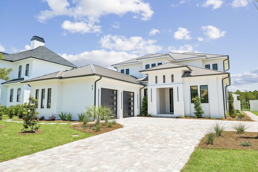 Behind the gates of Watersound Camp Creek, this newly constructed modern masterpiece was designed for buyers who refuse to compromise. Warm white oak finishes and clean architectural lines create a home that feels both sophisticated and effortlessly livable. Expansive Eurowall accordion sliders open completely to a private outdoor retreat featuring a resort-style pool, putting green, outdoor kitchen, and peaceful pond frontage.
Built with exceptional craftsmanship, the home features Sierra Pacific clad impact windows with thermal insulation, pivot entry doors, white oak interior doors with hidden hinges, wide-plank white oak hardwood floors, and sleek custom cabinetry finished with premium hardware throughout.
A detached pool house offers endless possibilities--ready to become a private guest suite, studio, wellness space, or executive office. Three balconies overlook Point Washington, while the standing seam metal roof and striking modern design set this home apart from anything else on 30A.
Included is the coveted Watersound Club membership with access to a private beach club, three championship golf courses, and exclusive restaurants and amenities. This is not a cookie-cutter spec home--it is a true luxury coastal estate built for the buyer who wants one of the finest modern homes on the Emerald Coast.