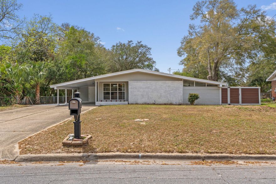 Brick 3BR/2BA with bonus Florida Room on a 0.39-acre fenced lot in Mary Esther. Open living and dining area flows into the kitchen with stainless steel range hood. Primary bath features an updated tiled walk-in shower with mosaic accent strip. Step into the Florida room for extra space to relax and enjoy the beautiful Florida sunshine. Large rear deck overlooks a spacious fenced backyard shaded by mature oaks & plenty of room for a future pool or outdoor entertaining. AC replaced 2021, water heater 2025. Less than 2 miles to Hurlburt Field, approximately 12 miles to Eglin AFB. Azalea Park steps away with future picnic areas and jogging trail. Sugar-white beaches just over the bridge from Miracle Strip Parkway. Destin 20 miles.  No HOA. Schedule your showing today.