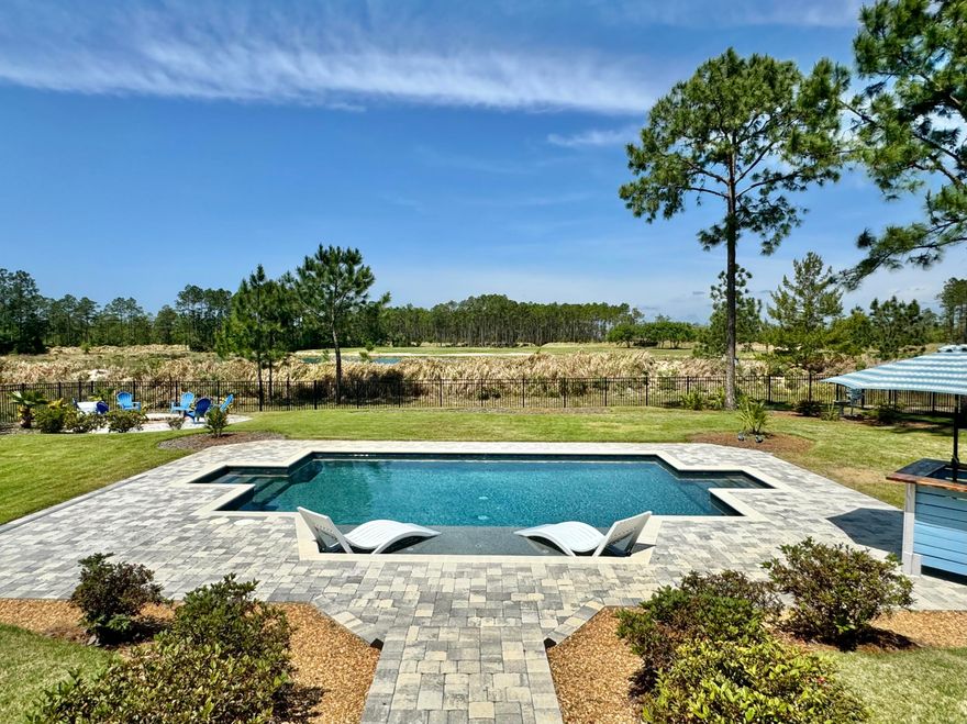 Welcome to this beautifully designed 2020-built home situated on a .59 acre premium golf course lot with peaceful water views and a spacious fenced backyard. Offering the perfect blend of luxury and functionality, this property is built for both comfort and entertaining. Enjoy ample parking with a two-car garage plus a separate golf cart garage -- all with epoxy flooring. Additional upgrades such as a tornado shelter and reverse osmosis system. The private backyard retreat is a showstopper featuring a screened porch, fire pit, putt-putt area, and a 15x25 gunite sports pool with heating and cooling, tanning ledge, bubblers, and autofill. Inside, you'll find abundant natural light, hard surface flooring, raised ceilings, curved archways , and both formal and informal living and dining spaces anchored by a cozy fireplace. The chef's kitchen features white quartz countertops, a large island with breakfast bar, smooth surface range, and an oversized walk-in pantry. The primary suite includes a flexible bonus area ideal for a home office, nursery, or gym. Luxury, recreation, and thoughtful upgrades   all in one exceptional home. Windswept amenities include pickle ball, tennis, basketball, playground, pool and more!
Lot next door is available, it's .59 acre and allows for the privacy or create your own estate. $123k premium water view and golf course lot.