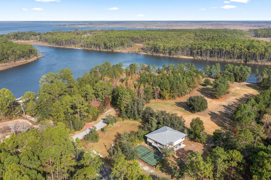 Built high and dry, this beautifully updated residence offers 3 bedrooms and 2 baths on the main level, including a dedicated bunk space perfect for kids or guests.  This home also offers additional sq footage as a private ground-level guest suite with a 4th bedroom ideal for extended family or visitors.

Designed for relaxed coastal living, the home features expansive covered outdoor space beneath the main level--perfect for entertaining, parking, or storing all your recreational toys. Enjoy quiet mornings on the front porch or unwind on the covered back deck that spans the entire width of the home, with direct access from the primary suite, guest room, living area, and kitchen. Set on over an acre of lushly landscaped grounds, there's ample room to roam, add a pool, garden, or simply enjoy complete privacy. For active lifestyles, the property also boasts its own pickleball court and volleyball court--bringing resort-style amenities right to your backyard.