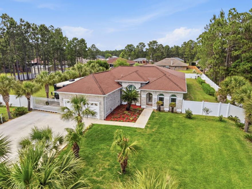 Multi generational home! Extraordinary, brilliantly designed one-level luxury estate offering 4,204 sq ft of beautifully remodeled space on a private 1-acre lot, perfectly suited for multi-family living, extended family, or luxurious entertaining. This stunning 5-bedroom, 3-bath residence captivates from the moment you arrive with its white Veretta stone brick exterior, lush landscaping featuring over $148,000 in upgrades, and 33 majestic palm trees creating a resort-style atmosphere. Inside, enjoy luxurious ceramic tile throughout, a flowing sitting room into an elegant formal dining room, and two oversized great rooms designed for both comfort and grandeur. The home features two kitchens, two HVAC systems, two hot water heaters, and three full bathrooms, offering unmatched functionality flexibility; The primary suite is a true private retreat, complete with an oversized bedroom, private den/TV room, office area, two large closets, 19" tile floors, cultured marble double vanity, and a spa-style tub/shower unit; Designed for ultimate versatility, the rear of the home can be separately locked and utilized as a luxurious mother-in-law suite, offering its own private great room, two bedrooms, full bath, and an updated kitchen adorned with stainless steel appliances, granite countertops, and designer backsplash, creating an opulent, independent living space. Outdoor living is equally impressive, showcasing over $48,000 in professional landscaping, highlighted by 33 mature palm trees, an oversized driveway with automatic electric gate for security and privacy; and dedicated electrical gated RV/boat parking with hookups. Beautiful and captivating 6 ft white privacy fence; Every detail of this property reflects thoughtful craftsmanship and upscale living. A truly rare offering that seamlessly blends luxury, space, and multi-generational flexibility, this remarkable estate must be experienced to be fully appreciated. The wow factor continues with a large entertainment room plus additional office space, flowing seamlessly to a screened lanai, perfect for outdoor entertaining. Additional highlights include an automated electric entry gate to the rear driveway, oversized driveway with RV/boat parking and hookups, and a backyard storage shed. Finished in beautiful neutral palettes, this one-of-a-kind property blends opulence, comfort, and versatility, delivering a rare opportunity for luxury living with exceptional multi-generational appeal. Rare gem for unmatched paradise! HVAC 2023 and 2021; Water Heaters 2025 and 2022; Waste 58.00 month; water $87.00 month; cable $208 month; electric average $350 month;