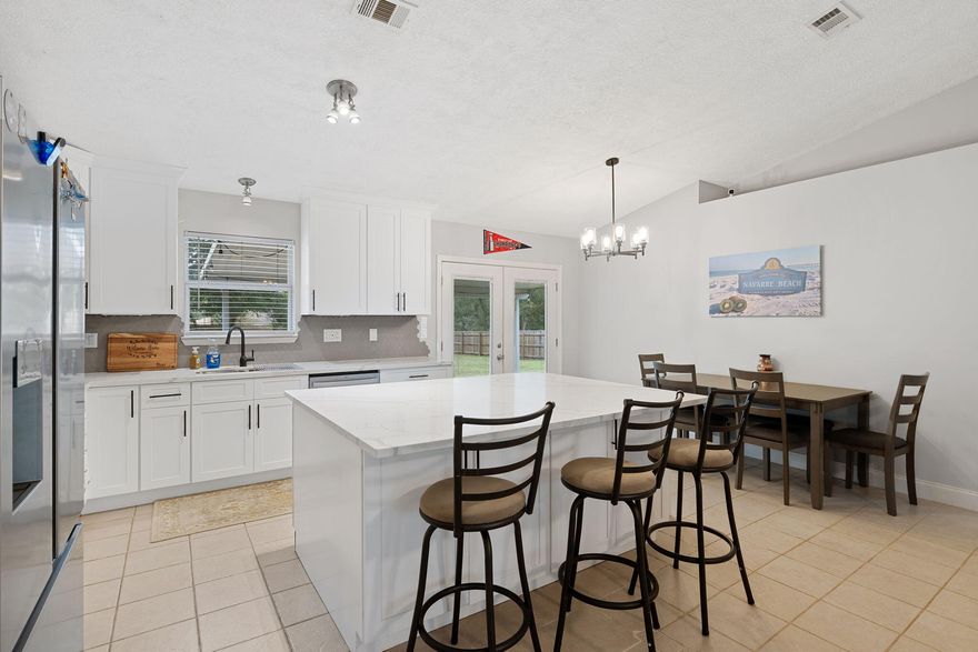 This rare find in Navarre is the one you've been looking for. Tucked away on a quiet low-traffic cul-de-sac, this home gives you peace of mind with major updates already complete, including a newer roof (2022) and newer HVAC (2022). The centerpiece of the open floor plan is the beautiful kitchen, fully remodeled in 2022. It features a large custom island that's perfect for gathering and loaded with smart storage. Enjoy quiet living on a spacious almost half acre lot featuring a large privacy fenced backyard with plenty of room for everyone, all while being less than 3 miles from the beach. Convenient to Hurlburt Field, parks, shopping, restaurants, and schools, this location is convenient to everything you need. It's move-in ready and checks every box. Call to set up your showing today