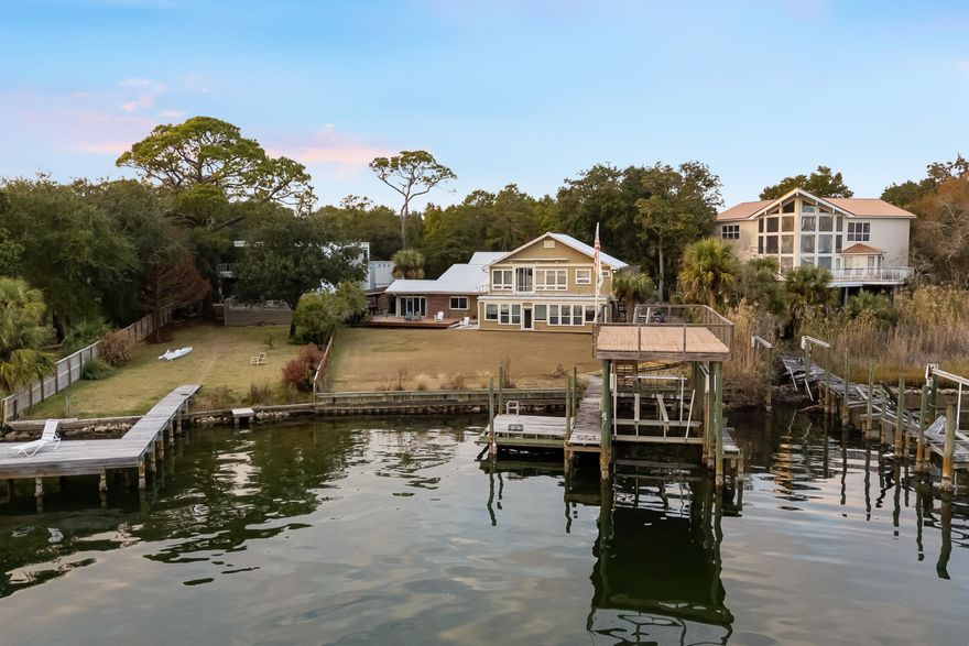Live the ultimate waterfront lifestyle in Shalimar, where boating season, sunset views, and coastal living come together just minutes from Crab Island and the Gulf. Situated on a rare half-acre lot with 82 feet of waterfront, this expansive 5-bedroom, 3.5-bath home with over 4,100 square feet is designed for those who want space, comfort, and direct access to life on the water.

Step outside to your private double-decker dock featuring power, water, a 10,000 lb boat lift, and a fish cleaning station--perfect for days spent boating, fishing, or paddleboarding right from your backyard. Enjoy a quick 10-minute boat ride to Crab Island, then return home to unwind in the hot tub while taking in breathtaking sunset views over the water.
Inside, the home offers an open-concept layout filled with natural light and water views, creating a seamless connection between indoor and outdoor living. The kitchen is a true focal point with custom concrete countertops, a Wolf gas range, and a ZLINE drawer microwave, blending function and style for everyday living and entertaining. New luxury vinyl plank flooring adds a fresh, modern feel throughout.

Multiple living spaces provide flexibility for gathering and relaxing, while a dedicated home office makes working from home easy. The split-bedroom floor plan offers privacy, with two bedrooms and a full bath on the main level. Upstairs, the spacious primary suite features a private balcony with panoramic water views, along with two additional bedrooms and another full bath.

Outdoor living continues with a built-in grilling station, ideal for hosting and enjoying warm coastal evenings. In addition to the attached two-car garage, the property includes an oversized RV garage and workshop, perfectly suited for a Class B RV, boats, and all your waterfront gear. A whole-house Generac generator adds peace of mind and reliable backup power.

With direct boating access, expansive water views, and space for all your coastal lifestyle needs, this property delivers the kind of waterfront living buyers are actively searching for along the Emerald Coast.

Flood insurance is required, and an elevation certificate is available.