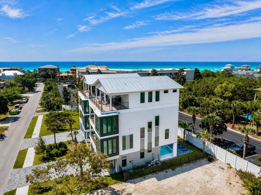 Brand-new and just finished, this four-story beach retreat sits south of Scenic Highway 30A on Mary Street, less than a 5-minute walk to the white sand beaches and emerald green waters of Blue Mountain Beach, Fla. Designed as a true rental powerhouse with projections around $235,000, this 5BR/5BA+2 half bath home is built for fun, comfort, and income. The first level lives like a poolside cabana, with a mini kitchen, half bath, and a full wall of sliders that open straight out to the private pool and sun deck—perfect for entertaining. Upstairs, the main living floor offers a large open kitchen, dining, and living area with Thermador appliances, a gas range, a sweeping island, and a walk-in pantry, ideal for big groups to gather. The whole second floor is dedicated to this open