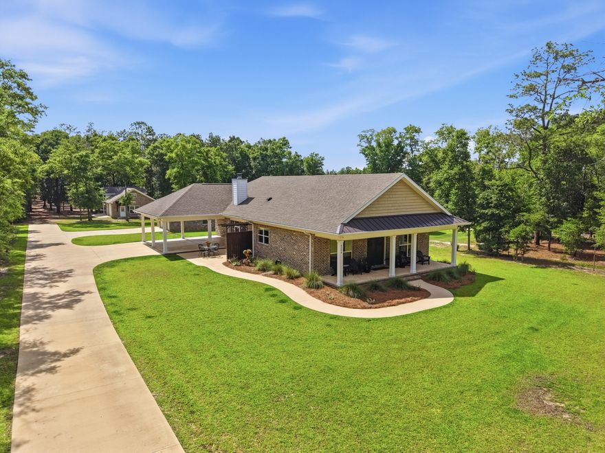 This is not your typical Crestview listing. 6004 Staff Rd delivers 3.31 secluded acres, a meticulously crafted brick home, and an outdoor infrastructure that rivals a small private estate. All without a homeowners association and minutes from everything this city has to offer.
Built in 2020 by a reputable, experienced local builder, this 1,971-square-foot single-story home was designed with intentionality from the foundation up. Spray foam insulation keeps utility costs in check year-round, brick construction ensures lasting curb appeal and structural durability, and ceramic tile flooring runs throughout the living areas with clean drywall finishes and a central ducted HVAC system that handles the Northwest Florida climate with ease.
The split floor plan offers three bedrooms and 2.5 bathrooms arranged for maximum privacy. The primary suite is a standout, anchored by an exceptionally spacious walk-in closet that connects directly to the laundry room. It is the kind of detail that sounds minor until you experience how much it elevates daily life. The 2.5-bath layout keeps shared spaces functional for visiting guests and secondary bedrooms alike.
The heart of this home is the screened porch, accessed directly from the kitchen. This configuration creates an effortless indoor/outdoor connection that anchors daily life here. A wood-burning fireplace makes it a legitimate four-season room: a place to curl up with a book on a rainy afternoon, entertain on a cool fall evening, or simply breathe in the sounds of the property. An uncovered patio extends the outdoor footprint beyond the screen, and a covered front porch invites the kind of slow-morning living that Crestview was built for.
Step beyond the home and the property earns its price point. Two fully powered detached garages offer storage and utility that most properties in this price range simply cannot match. The first is a generous one-car structure. The second is a two-car garage with an additional roll-up door on the opposite end sized for a riding mower, and water has been run directly to this structure. Attached to the two-car garage is a covered, high-clearance bay built specifically for RV or boat storage. A separate covered carport provides a third vehicle space with ease.
The 3.31-acre lot is designed to surprise you. The front of the property maintains an approachable presence close to the road, but drive back through the corridor of mature trees and the land opens into a cleared, private section that feels entirely removed from the outside world. It is a rare feature in a location this convenient to Crestview's shopping, dining, and services. The grounds have been maintained with exceptional care, and established raised garden beds add color and purpose to the exterior.
No HOA. No restrictions. No compromise.
Located in unincorporated Okaloosa County, 6004 Staff Rd is minutes from the Hwy 85 and Hwy 90 corridor and within comfortable distance of Eglin Air Force Base, Duke Field, and all that Northwest Florida has to offer. Custom-built, meticulously maintained, and one of a kind. Properties like this do not come available often. Schedule your private showing today.