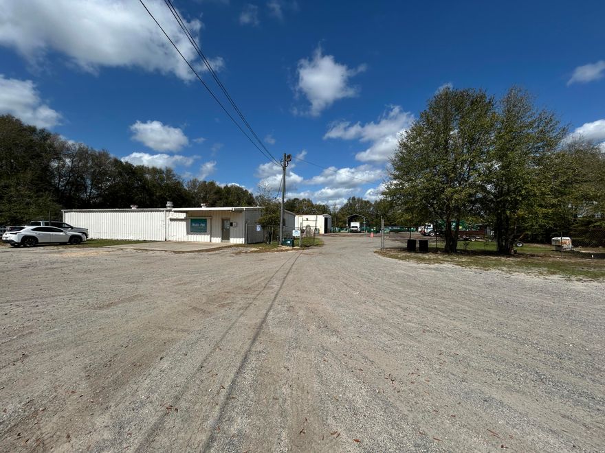 Rare opportunity to acquire a fully fenced contractor yard with fleet storage and warehouse space on 2.53± acres (two parcels) in Crestview's growing commercial corridor. The property includes approximately 8,280 SF across two buildings with large secure yard space and convenient access to Highway 90 and Interstate 10, making it ideal for businesses that require equipment storage, truck parking, and operational warehouse space.  Well suited for dump truck companies, excavation and site work contractors, septic service companies, roll-off dumpster operators, utility contractors, trucking or logistics companies, heavy equipment operators, disaster restoration contractors, or construction companies needing a secure yard and service facility. he front building provides a functional office and warehouse operations base with reception area, two offices, breakroom, two restrooms, and warehouse storage with a 10' roll-up door. The rear service building includes 16' clear height truck bays, a covered truck port, and mezzanine storage, making it well suited for fleet maintenance, equipment service, or contractor operations.

The fully fenced yard offers extensive space for truck parking, fleet storage, dumpsters, trailers, equipment, and material staging, a key feature for companies operating across Okaloosa and Walton counties.

The property is currently leased to Waste Pro at $4,000 per month on a month-to-month lease, providing immediate income for investors while maintaining flexibility for an owner-user. Tenant will vacate with 90 days notice if the buyer prefers to occupy the property.

Zoned Mixed Use (MU), which allows a wide variety of residential and commercial uses intended to encourage flexible redevelopment and business operations within the district. 

The site participates in Florida's petroleum restoration monitoring program related to historic operations. Monitoring wells remain on site and must remain accessible but do not prevent normal site use or development of the property. 

Located just minutes from Highway 90 with quick access to Interstate 10, the property offers excellent regional connectivity for construction, logistics, service, and distribution businesses throughout the Florida Panhandle.  Call today for more info.

Buyer to verify all information and property details.