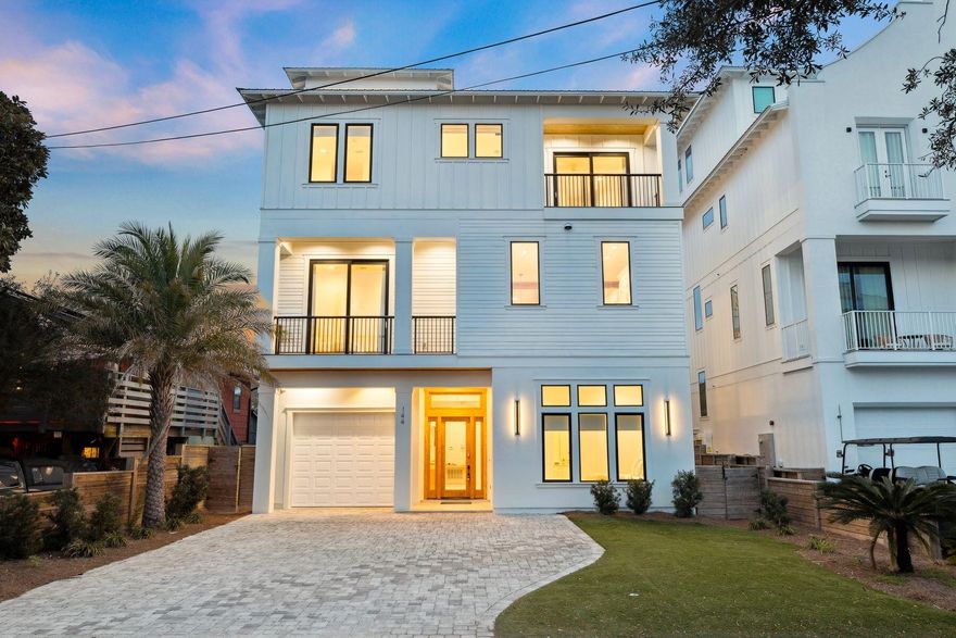 Some beach houses are simply places to sleep between beach visits; this one is the destination itself. Completed in 2021, this four-story, sleek coastal contemporary in Frangista Beach is the ultimate expression of Gulf Coast living - eight bedrooms, eight ensuite baths, and a visionary layout that wraps breathtaking views around every gathering space, every private balcony, every quiet morning moment.

Soaring beamed ceilings, 24'×48' tile floors, and floor-to-ceiling slider doors create a sense of openness that feels as boundless as the water beyond. The sophisticated second-floor living room drinks in natural light through picture windows, while the all-white chef's kitchen - with Fisher & Paykel appliances, a gas range, a wine cooler, and a glittering quartz island - invites long, leisurely meals that stretch well into the evening.

Below, the ground-floor game room sets the tone for pure fun: pool table, a sleek wet bar, and doors that spill directly onto the pool deck. Here, a resort-style pool and hot tub shimmer within a privacy-fenced backyard, flanked by an outdoor kitchen and lounge built for golden-hour entertaining. And above it all, the rooftop terrace with gulf views - part covered retreat, part open-air perch - offers an outdoor kitchen, a crackling fire pit, and the kind of sunsets that make guests lose track of time entirely.

With accommodations for up to 18 guests across six king beds, four queen beds, and six twin bunks, a 3-stop private elevator, two laundry sets, and a garage perfectly sized for a car or golf cart, every logistical detail has been quietly solved. Gated beach access for Frangista Beach at Hollywood Street is just a short stroll away, with fine dining, coffee shops, ice cream parlors and boutique shopping minutes down Scenic 98. Recently refreshed and ready for its next chapter.