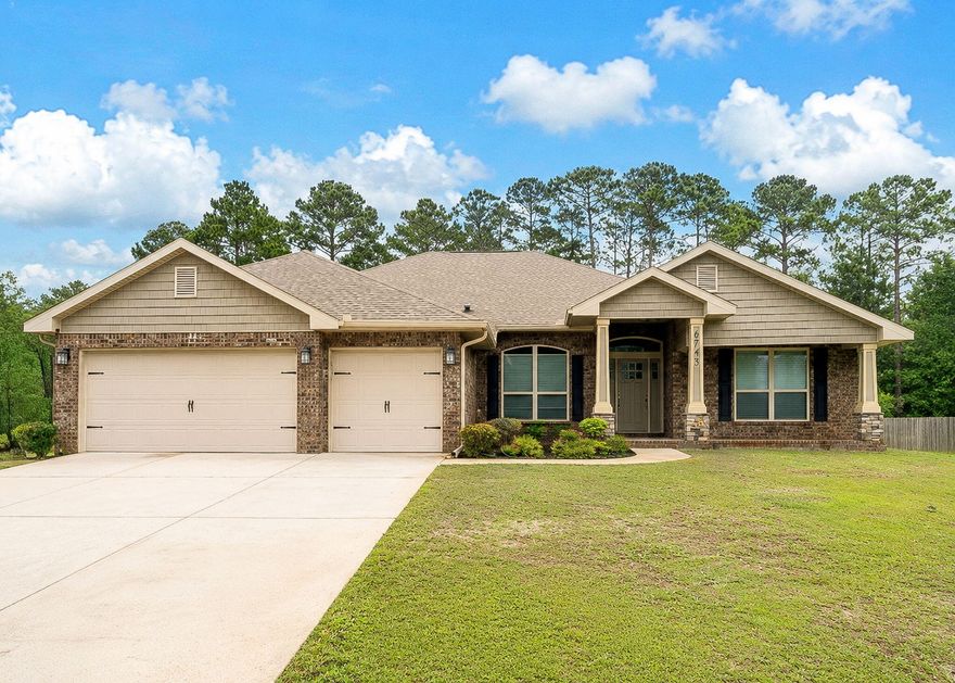 This expansive 2018-built home sits on a generous 0.88-acre lot and makes a striking first impression with its elegant stone column entry and covered front porch. The lot stretches 293ft behind the back door of the house through the wooded lot! Inside, you'll find soaring ceilings, dramatic archways, and a stunning stone-accented fireplace that anchors the main living space. The kitchen is thoughtfully upgraded with stainless steel appliances, granite countertops, an enhanced sink and faucet, a pantry, and a convenient breakfast bar overlooking a bright nook with bay windows.  The living room is spacious and inviting, featuring high ceilings, dual ceiling fans, and a beautiful stone fireplace with a mantel and slate hearth. Durable CoreTec Pro luxury vinyl plank flooring flows throughout and leads seamlessly into the formal dining area. The primary suite offers a relaxing retreat with a recessed box ceiling, ceiling fan, dual walk-in closets, and private access to the covered lanai. The en-suite bath includes separate granite-topped vanities, a tiled walk-in shower with glass enclosure, and a garden tub with tile surround. A well-designed split floor plan includes a private second bedroom with its own bathroom. Bedrooms three and four are generously sized. A versatile 14x13 bonus room or office features double glass French doors, vaulted ceiling, large window, ceiling fan, and upgraded LVP flooring. An additional full bath serves bedrooms three and four and also provides direct access to the lanai - perfect for future pool use! Additional highlights include a three-car garage, a dedicated laundry room with cabinetry, and a large storage shed with windows, standard entry, and roll-up side door. The home also features gutters, overhead garage storage, arched doorways, under-cabinet kitchen lighting, an exterior-vented microwave, hurricane fabric shields, an irrigation system with well pump, and an outdoor rinse shower. Conveniently located just half a mile from the HOA's deeded East Bay boat launch, with easy access to local beaches, Hurlburt Field Air Force Base, and nearby shopping. HOA amenities include access to a multi-million-dollar recreation center featuring clay tennis courts, a beach house event hall, fishing dock, RV and tent campground, multiple pools, fitness center, locker rooms, volleyball court, ball field, basketball court, and more.
