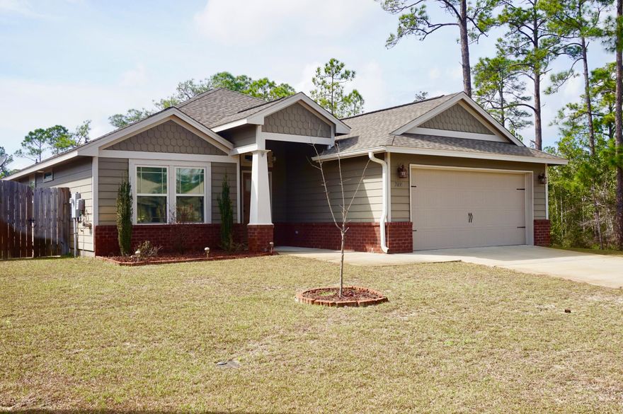 Simply Said....Welcome Home ~If your looking for that move in ready home ~Here it is, this wonderful family home is less than 4 years old and offers an ideal East Navarre location in a no through road sub-division and situated at the end of a cul-de-sac wrapped by Greenbelt land ~Great family living space, your 3bed/2bath split floor plan home is fully fenced with a huge back yard ~lawn pump and sprinkler system for easy care in the summer months~just minutes from the beach and short drive to Hulburt Field.Home offers great curb appeal,covered front porch with brick accents and craftsman columns. Entering the home you will appreciate the open flow to the great family room with high ceilings, crown molding and open flow to the large dining area with trey ceiling ,crown molding and double patio doors to the back garden and covered back porch that faces West ...to enjoy those Wonderful Florida evenings, Gorgeous kitchen with , huge hop up breakfast bar ,under mount sink , lots of cabinet space~ granite counter tops,rich colors and stainless steel appliances, pantry and utility room which opens to the finished garage with pull down stairs .Master bedroom with trey ceiling and center fan,Master bath has double vanity, large step in shower and separate WC. Additional bedrooms are a good size with large walk in closets and additional bathroom with tub/shower .Home is beautifully decorated throughout with earth tone colors and a great feeling of space in every room. Close to the beach, base and local stores...call today to make an appointment to view this wonderful move in ready home.