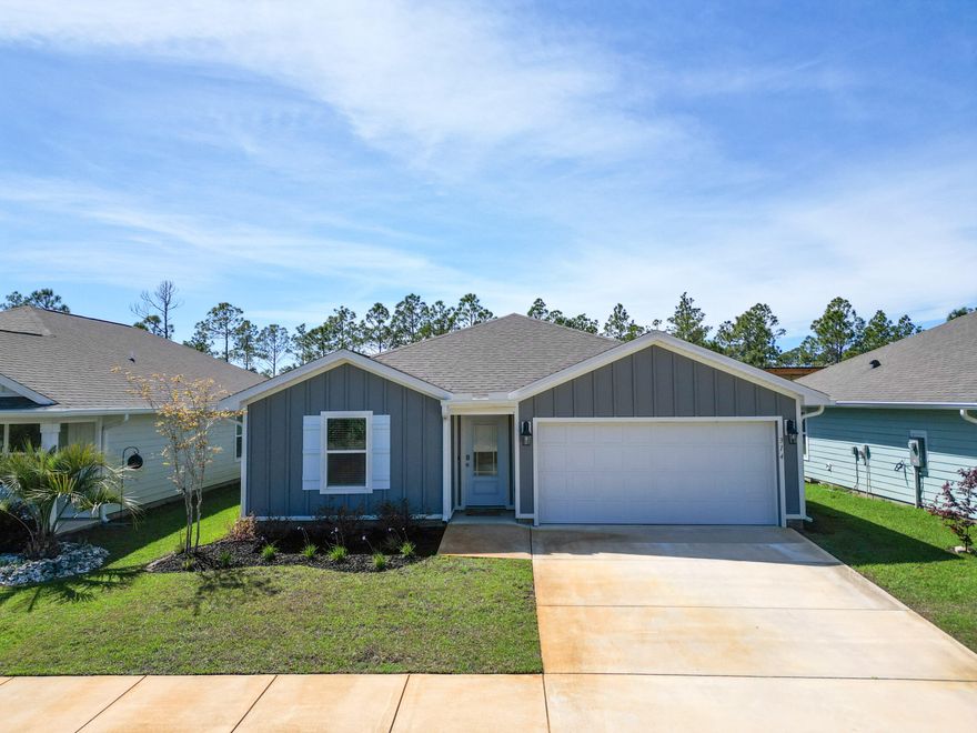 Nestled in the charming coastal town of Port St. Joe, Palmetto Bluff offers the perfect blend of comfort and convenience. Just minutes from pristine beaches, the iconic lighthouse, and a variety of local dining favorites, this vibrant area also hosts frequent festivals and live music events. With Cape San Blas just a short drive away, outdoor adventure and relaxation are always within reach. Step inside the Freeport floor plan through the inviting prairie-style front door and immediately notice the bright, welcoming entryway. This thoughtfully designed 4-bedroom, 2-bath home spans 1,387 square feet and features an open-concept layout ideal for both everyday living and entertaining. At the front of the home, two bedrooms share a full bathroom, while an additional bedroom sits just across the entry hall--providing privacy and flexibility for guests or family members. The spacious kitchen, complete with a large island, overlooks the dining and living areas, creating a seamless flow that keeps everyone connected while allowing for individual activities. Durable and stylish engineered vinyl plank flooring runs throughout the main living areas, bathrooms, and laundry room, while the bedrooms offer soft, plush carpeting for added comfort. The generously sized primary suite serves as a private retreat, featuring a walk-in closet and an en-suite bath with a large shower and single vanity.