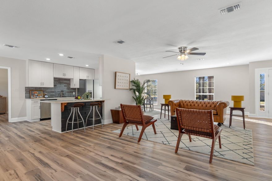 Wake up to quiet mornings where rustling leaves replace traffic noise and nearly a full acre of level, usable land stretches beyond your back door. This fully remodeled four-bedroom, two-bath home blends modern finishes with the freedom of space inside and out.
Step through the front door and feel the openness immediately. Luxury vinyl plank flooring flows throughout, guiding you into a bright, open layout designed for effortless living. Natural light fills the space, reflecting off quartz countertops, soft-close cabinetry, and stainless steel appliances in a kitchen that feels both refined and functional. Updated LED recessed lighting and modern fixtures add a clean, contemporary finish throughout. The living room centers around a wood-burning fireplace with modern farmhouse styling, a warm focal point that anchors the space. Generously sized bedrooms offer flexibility for a variety of needs, while both bathrooms feature granite countertops and custom tile showers. The primary suite includes a tiled walk-in shower, creating a private retreat within the home.
Step outside and the lifestyle expands. The level yard offers a mix of open space and mature trees ideal for gardening, entertaining, adding a workshop, installing a pool, or simply enjoying the outdoors at your own pace. With no HOA restrictions, the possibilities are yours to define.
A new HVAC system and new water heater add peace of mind, making this home truly move-in ready.
Recently reduced over $20,000. This is space, style, and freedom in one address.