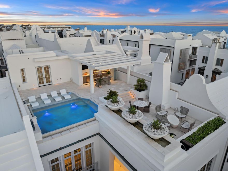 Welcome to 13 La Garza Court - a breathtaking architectural residence in the iconic community of Alys Beach. Thoughtfully designed for elevated coastal living, this home spans 4,844 square feet, blending modern sophistication with timeless Mediterranean influence. The addition of a fourth bedroom is an option, should a Buyer wish to modify the layout, as articulated by the included design renderings and contractor's proposal. A dramatic private courtyard sets the stage, leading to a sweeping staircase and striking architectural details that establish an elegant tone. Light-filled interiors flow seamlessly throughout, from the stunning great room with its wood-paneled ceiling and designer fireplace to the open-concept dining area and chef's kitchen, appointed with bespoke cabinetry, a custom range hood, and high-end appliances. Wide-plank hardwood floors and layered natural textures add warmth and depth at every turn. The home's centerpiece is an expansive rooftop terrace is an unrivaled private oasis in Alys Beach. An infinity-edge pool with a sun shelf and cascading water feature invites relaxation, while an adjacent outdoor kitchen with built-in grill, wet bar, and covered lounge area with TV provides the perfect setting for effortless entertaining from sunrise to sunset. Each bedroom serves as a private retreat with spa-like en suite baths, and an elevator provides convenient access to all levels. Multiple indoor and outdoor living areas offer the ideal backdrop for both quiet moments and lively gatherings. Capturing the beauty of the Emerald Coast and the unmatched lifestyle of Alys Beach, 13 La Garza Court represents a rare opportunity to own one of the community's most distinctive residences.