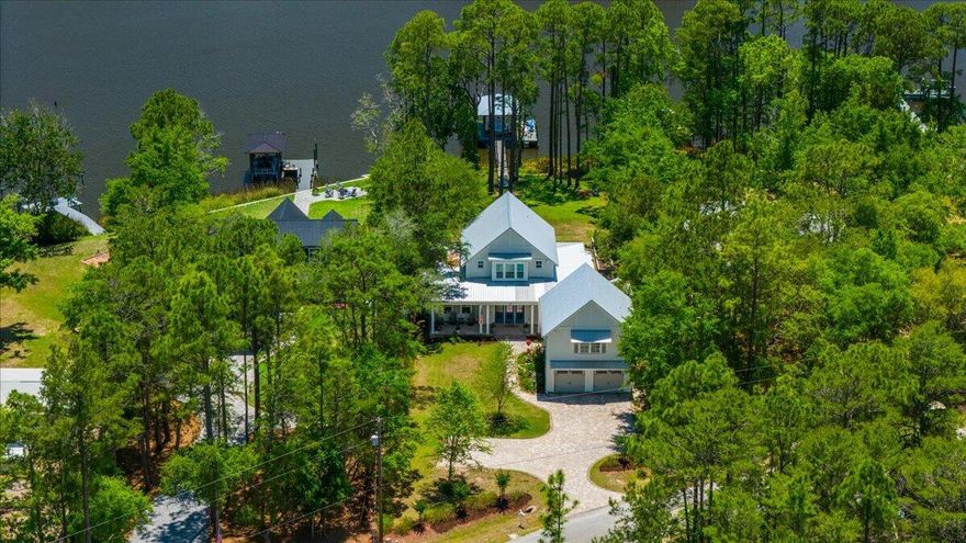 This coastal custom home is set on a protected bayou with serene water views. Enjoy your private dock which has $36k of upgrades that include a lift for a boat and 2 jet skis. The apartment above the garage offers versatility for an Airbnb or office. Enjoy Southern charm with brick pavers throughout, high ceilings, deep covered porches, including a 24x16 rear porch, and a fenced backyard with a small citrus grove. As a bonus, a 24kw whole-home generator supports both structures and the dock with 2 owned propane tanks. The main home offers 3bed/3.5 baths and a downstairs primary suite with a modern closet, soaking tub, and separate shower. The kitchen showcases an oversized island, gas range and extra storage in the kitchen galley. No HOA & room for a pool! Don't miss out A beautifully pavered driveway leads to the 2-car garage with a apartment above--complete with private bedroom, living area, bathroom, and kitchenette, ideal for rental income, guest suite, or office.

Located within easy reach of 30A, Blue Mountain Beach, and Grayton Beach, easy boating to North Beach and The Bay restaurants or head to Crab Island in Destin--perfect as a primary residence, second home, or investment opportunity.