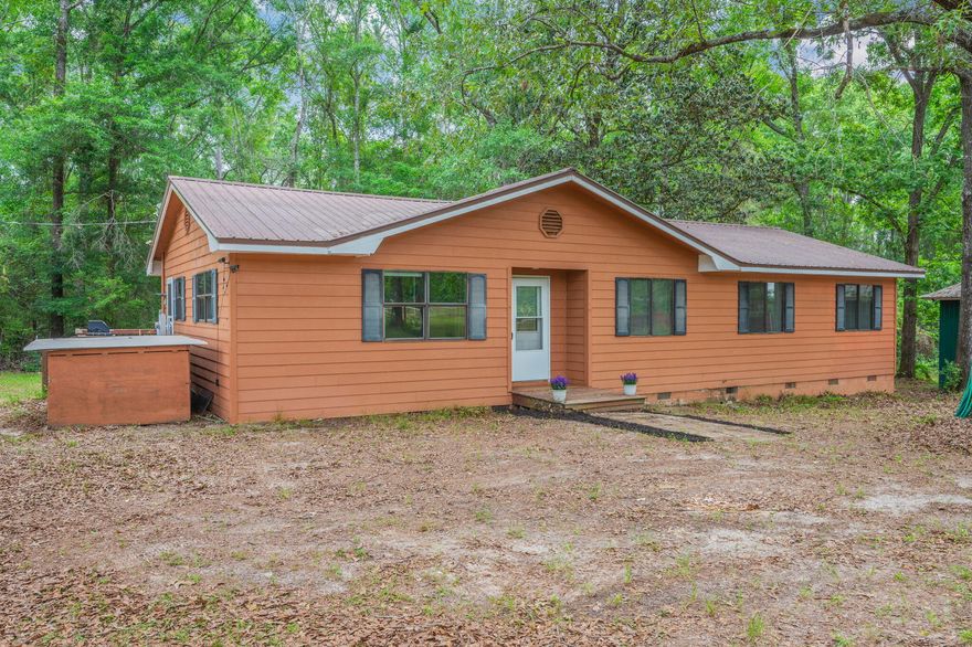 Country charm at its finest! This 4 bed/2 bath home is situated on 1 acre of land and fully fenced with a gate at the entrance to help keep out unwanted guests on those days you just don't want to be bothered (It's okay. We've all been there!!). The exterior is beaming with greenery all around including mature oak trees for lots of shade to enjoy the outdoors. Enjoy the back deck that wraps around to the side of the home with plenty of room for entertainment or just enjoying some peace and quiet to yourself. A big bonus is the fully enclosed detached garage with a lean-to added, providing plenty of room for storage, hobbies & workspace. There is also an additional fenced off area that would be perfect for gardening or even small livestock if desired. Step inside to an inviting foyer with a large living area to itself. The dining room, open to the kitchen, has a sliding glass door leading you out to the back deck. There is a small laundry area conveniently located next to the side door for ease of access. Thoughtfully designed offering all 4 bedrooms and 2 full bathrooms down the hall, creating a quiet, dedicated area away from the main living areas. With a little TLC this home could be just what you are looking for. An affordable home with privacy and comfort.
