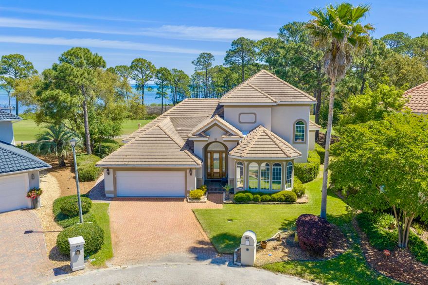 WHAT A VIEW! Catch your breath! The Choctawhatchee Bay, the Emerald Bay Golf Course and oh the sunset! This custom built one owner Bay Front home is on the 16th green and perfect for entertaining! Designed for your relaxed, elegant lifestyle! Soaring ceilings, crown molding and architectural details throughout! This house says QUALITY! Meticulously maintained and exquisitely appointed, this spacious home is ready to be enjoyed by you, your friends and family. Enter into the welcoming foyer and step into the expansive tiled great room with fireplace and wet bar. Enjoy sweeping golf course views from nearly every room, as the main living areas and primary suite open seamlessly to the outdoor space. No expense has been spared! The finishes in this home are first class and the space is very well utilized. Great storage, large living space & closets galore. The kitchen is as functional as it is inviting, with granite countertops, stainless steel appliances, a prep island, under-cabinet lighting, tiled backsplash, and custom cabinetry for storage.The en suite bath features a jetted tub, separate shower, dual vanities, a private water closet, and two closets, including a walk-in. Designed with everyday comfort in mind, the home also includes a laundry room and cabinetry. Truly move-in ready, this home offers a turn-key opportunity in one of the area's most sought-after communities. Located in an X flood zone with a low HOA, Emerald Bay provides access to golf, a clubhouse, tennis courts, and a community pool--all just minutes from shopping, dining, and the beach.