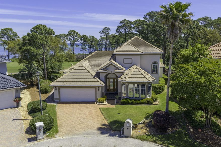WHAT A VIEW! Catch your breath! The Choctawhatchee Bay, the Emerald Bay Golf Course and oh the sunset! This custom built one owner Bay Front home is on the 16th green and perfect for entertaining! Designed for your relaxed, elegant lifestyle! Soaring ceilings, crown molding and architectural details throughout! This house says QUALITY! Meticulously maintained and exquisitely appointed, this spacious home is ready to be enjoyed by you, your friends and family. Enter into the welcoming foyer and step into the expansive tiled great room with fireplace and wet bar. Enjoy sweeping golf course views from nearly every room, as the main living areas and primary suite open seamlessly to the outdoor space. No expense has been spared! The finishes in this home are first class and the space is  very well utilized. Great storage, large living space & closets galore. The kitchen is as functional as it is inviting, with granite countertops, stainless steel appliances, a prep island, under-cabinet lighting, tiled backsplash, and custom cabinetry for storage.The en suite bath features a jetted tub, separate shower, dual vanities, a private water closet, and two closets, including a walk-in. Designed with everyday comfort in mind, the home also includes a laundry room with utility sink and cabinetry. Truly move-in ready, this home offers a turn-key opportunity in one of the area's most sought-after communities. Located in an X flood zone with a low HOA, Emerald Bay provides access to golf, a clubhouse, tennis courts, and a community pool--all just minutes from shopping, dining, and the beach.
