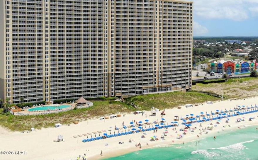 Fully booked so difficult to get a tour appointment; keep trying! This Emerald Beach condo on the 8th floor is worth it. Full of promises for breathtaking beach and sunset views. VA and short-term rental approved, it's designed for life at the beach like you've always imagined! Relax on the private balcony where salty breezes invite you to unwind and breathe. Inside, this elegant 2-bedroom retreat showcases a Gulf-front owner's suite with a luxurious king bed, walk-in closet, magnificent bay windows, and balcony access. The spa-like en-suite bathroom features a double vanity, relaxing jacuzzi tub, and walk-in shower. Down the hall, the guest room offers a queen bed, with bunk beds just outside the door--perfect for the children. Additional conveniences include a guest bathroom, stackable laundry, and owners' closet. This stylish beach haven boasts coastal décor, quality furnishings, 10' ceilings, crown molding, and durable tile and LVT plank flooring. The condo is safety-equipped with a leak detection system and fire sprinklers for peace of mind. The resort itself is a destination, offering unparalleled amenities. Take a dip in the beachfront pool and hot tub, grab a drink at the tiki bar, or stroll the boardwalk to the sand. The unique SkyBar bridges the amenity building and condo tower, hosting daily events and fun activities. Enjoy on-site conveniences like Starbucks, Sunsations Beach Shop, and a fitness center. For families, the children's world features pools, a snack bar, game room, shuffleboard, and activity center. Grown-ups can relax in shaded areas, grill, or float the day away while kids play nearby. The resort's walkable location gives you easy access to a retail center across the street, plus must-visit restaurants like Runaway Island and Senior Frogs. Pet lovers will adore nearby Pier Park's dog beach and Frank Brown dog park. This vibrant destination is buzzing with new attractions like Top Golf and Dolly Parton's Pirates Voyage Dinner & Show. Reach out today for a Cost To Own Estimate to see how rental income can cover ownership costs so you can comfortably slip into the coastal lifestyle of your dreams!