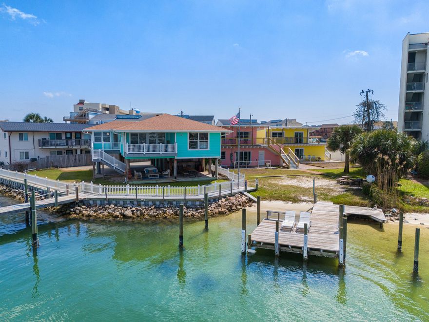 Please refer to MLS#999780 and GCCMLS #44646933. 
Rare waterfront estate featuring 4 x 2BR/1BA units and a studio both on a short-term rental program, and a 2BR/2BA 2,008 sq. ft. primary residence with panoramic water views from every window, an updated kitchen, and quartzite countertops. Enjoy stunning emerald waters, private beach, two private docks, and a fully equipped outdoor kitchen, just a 7-minute walk to the Gulf. This unique property blends luxury waterfront living with strong rental income potential, ideal for investors or anyone seeking a resort-style lifestyle on the water.