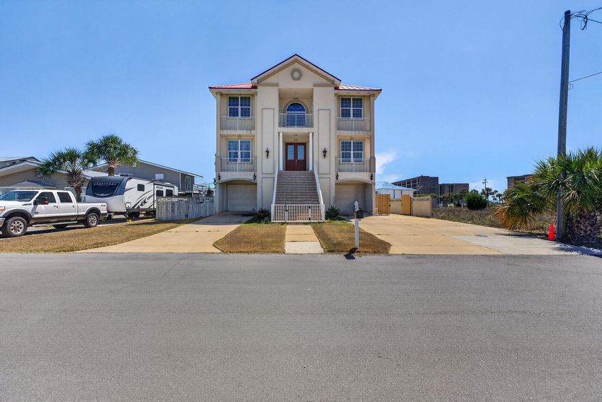 This large home with its gulf views and location across the street from a beach access is perfect for family getaways or company retreats.  As you walk into the house you are instantly hit with an elegant 20' foyer that is highlighted by a ceiling decorated as if you were looking at the sky and sets your mood perfectly for your stay at the beach.  There is an elaborate hardwood staircase, beautiful chandeliers, and comfortable furniture place throughout the house. The enormous kitchen is a gourmet's dream, with a large island/breakfast bar, with granite counter tops, white cabinets, and stainless-steel appliances.  As you explore the first floor you will find another family room, full kitchen with gas stove, dining room and two more bedrooms for your guests and entertaining.