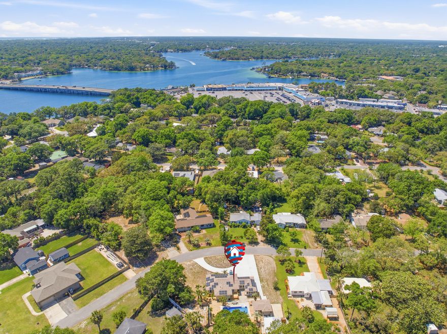 Welcome to this beautifully remodeled home by Randy Wise Homes offering modern upgrades, multiple living spaces, and exceptional outdoor living. Inside features fresh paint, updated flooring, an open layout, fireplace, built-ins, and a stunning renovated kitchen with quartz countertops, stainless steel appliances, double ovens, gas range, and oversized island. The vaulted sunroom with exposed wood beams provides the perfect space to relax or entertain. Bathrooms feature updated walk-in showers with built-in seating. Step outside to your private backyard retreat complete with an in-ground pool, spacious entertaining areas, and detached cabana with full bath.  An additional bonus flex space attached to the 1-car garage makes a perfect office, studio, or lounge area. Conveniently located near shopping, dining, schools, and major roadways in Fort Walton Beach.